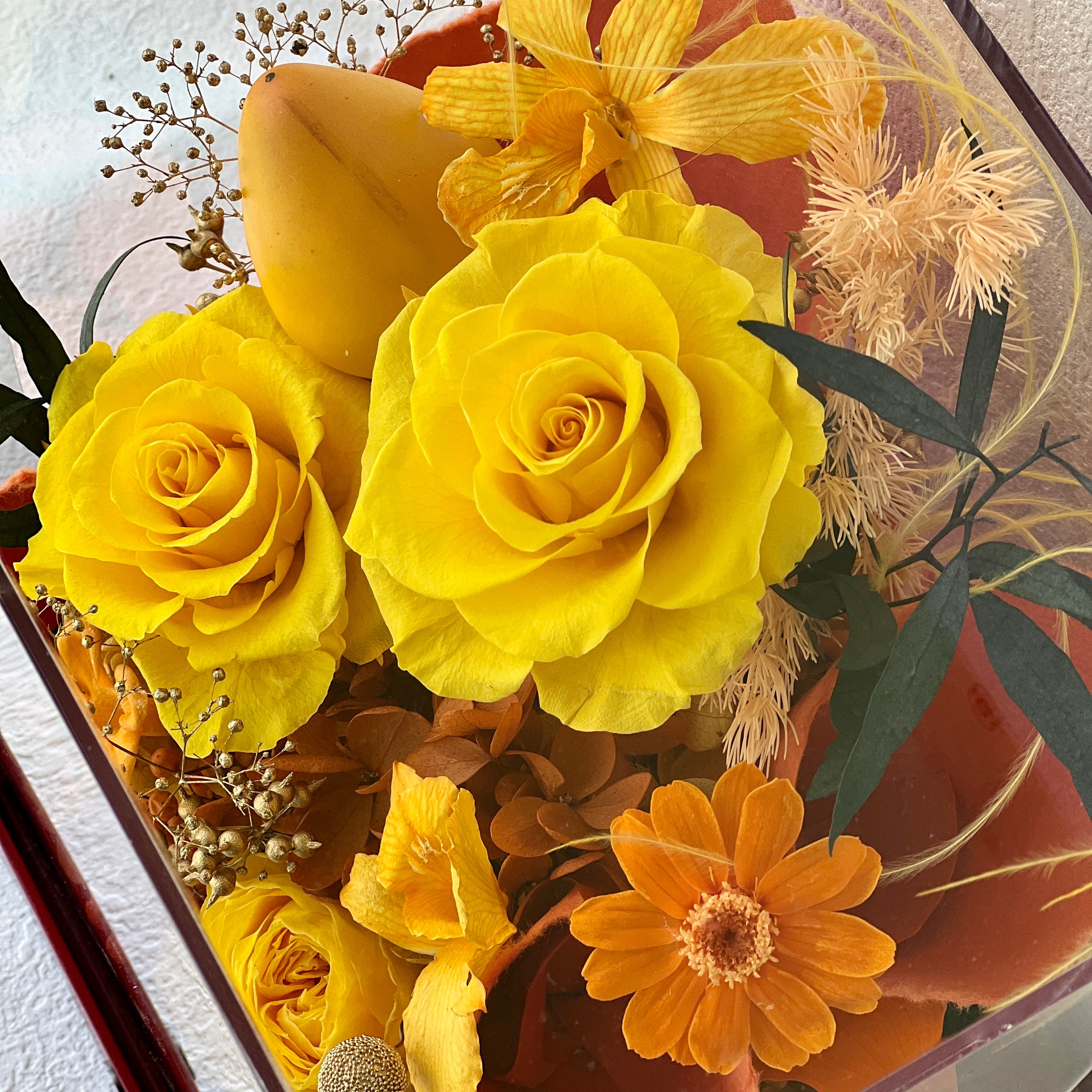 Mini Garden preserved flower arrangement featuring vibrant yellow roses and delicate clematis, elegantly displayed in a sleek acrylic box. A perfect eternity rose gift for bringing warmth and joy to any space.