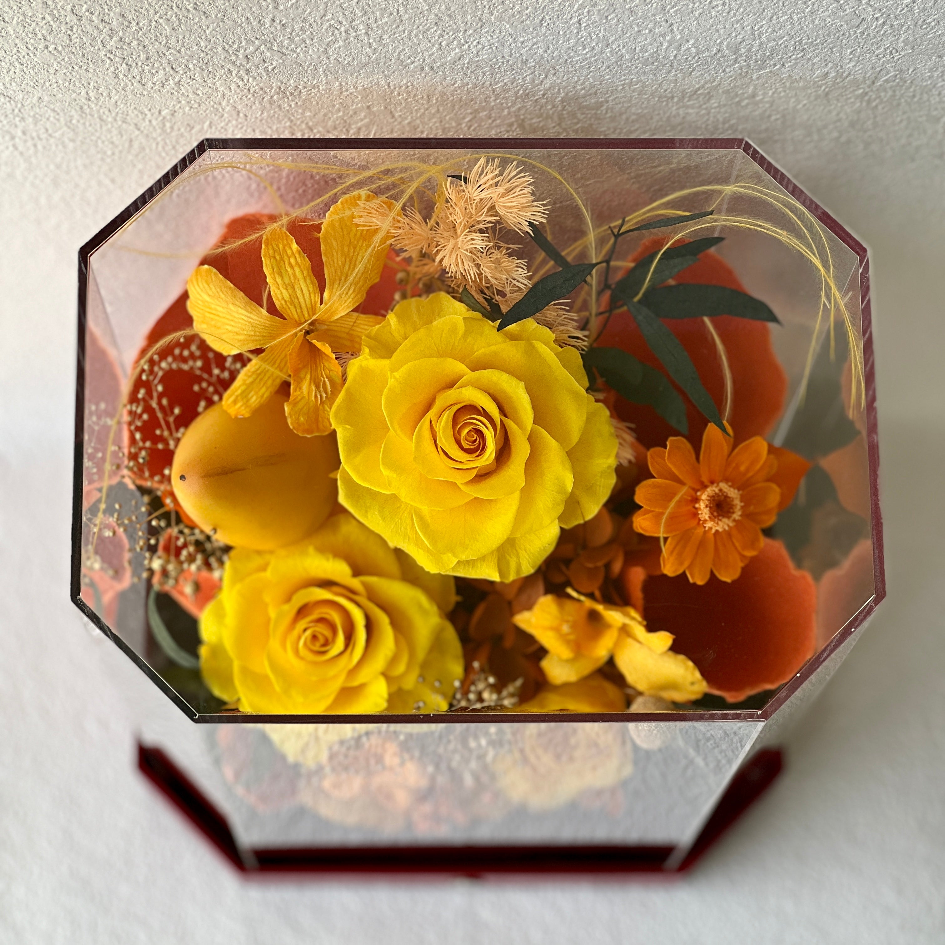 Mini Garden preserved flower arrangement featuring vibrant yellow roses and delicate clematis, elegantly displayed in a sleek acrylic box. A perfect eternity rose gift for bringing warmth and joy to any space.