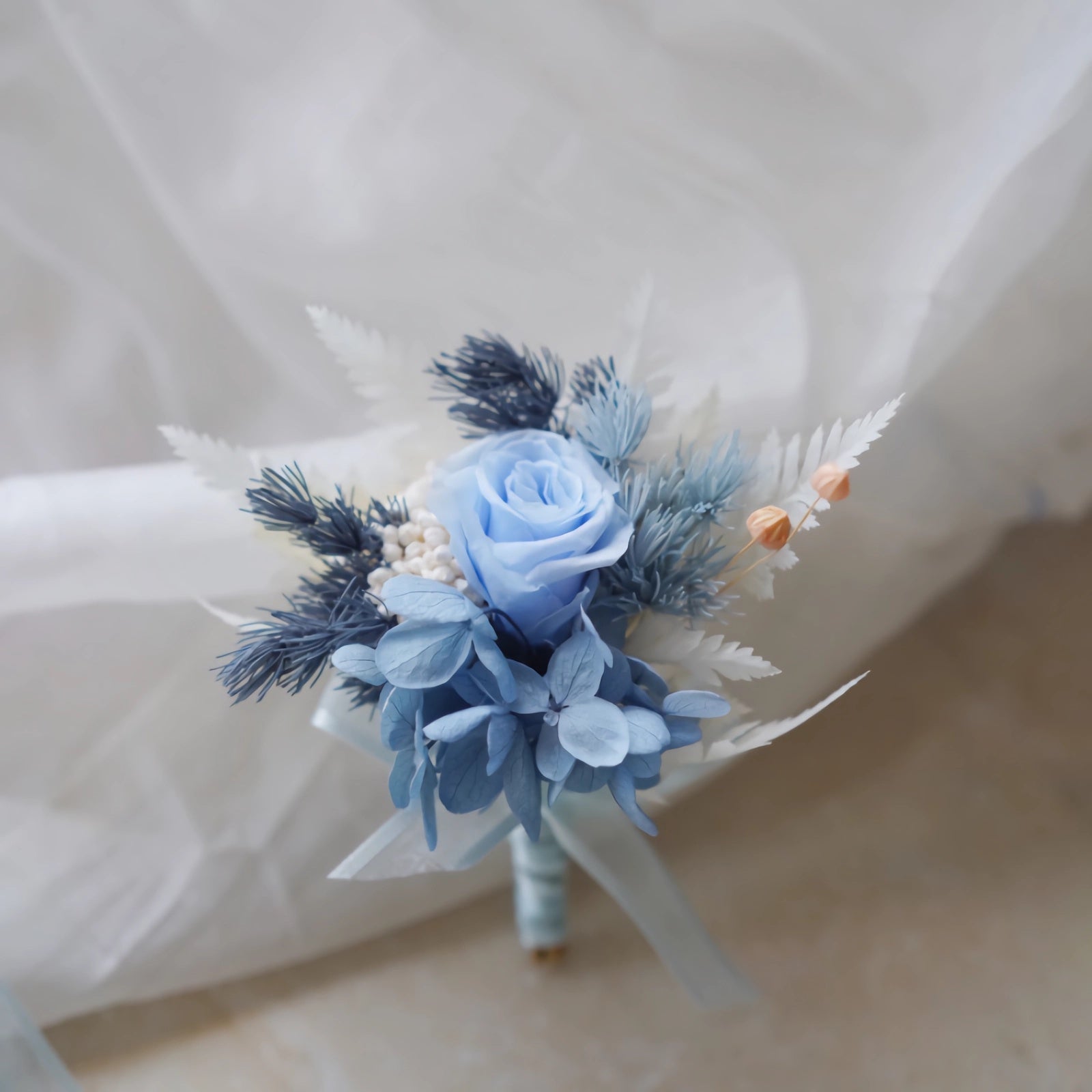 boutonniere with preserved blue rose