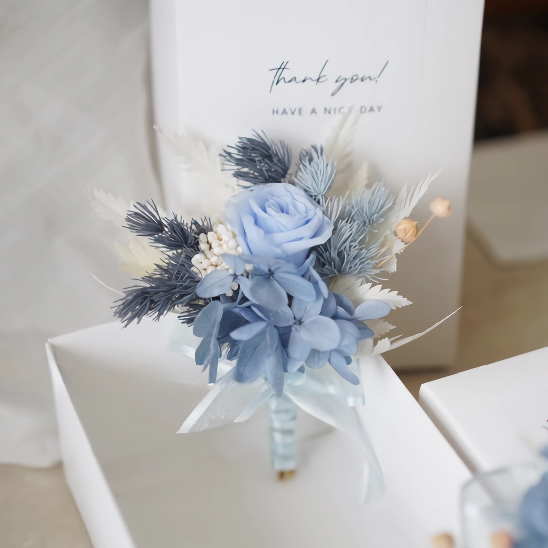 boutonniere with preserved blue rose