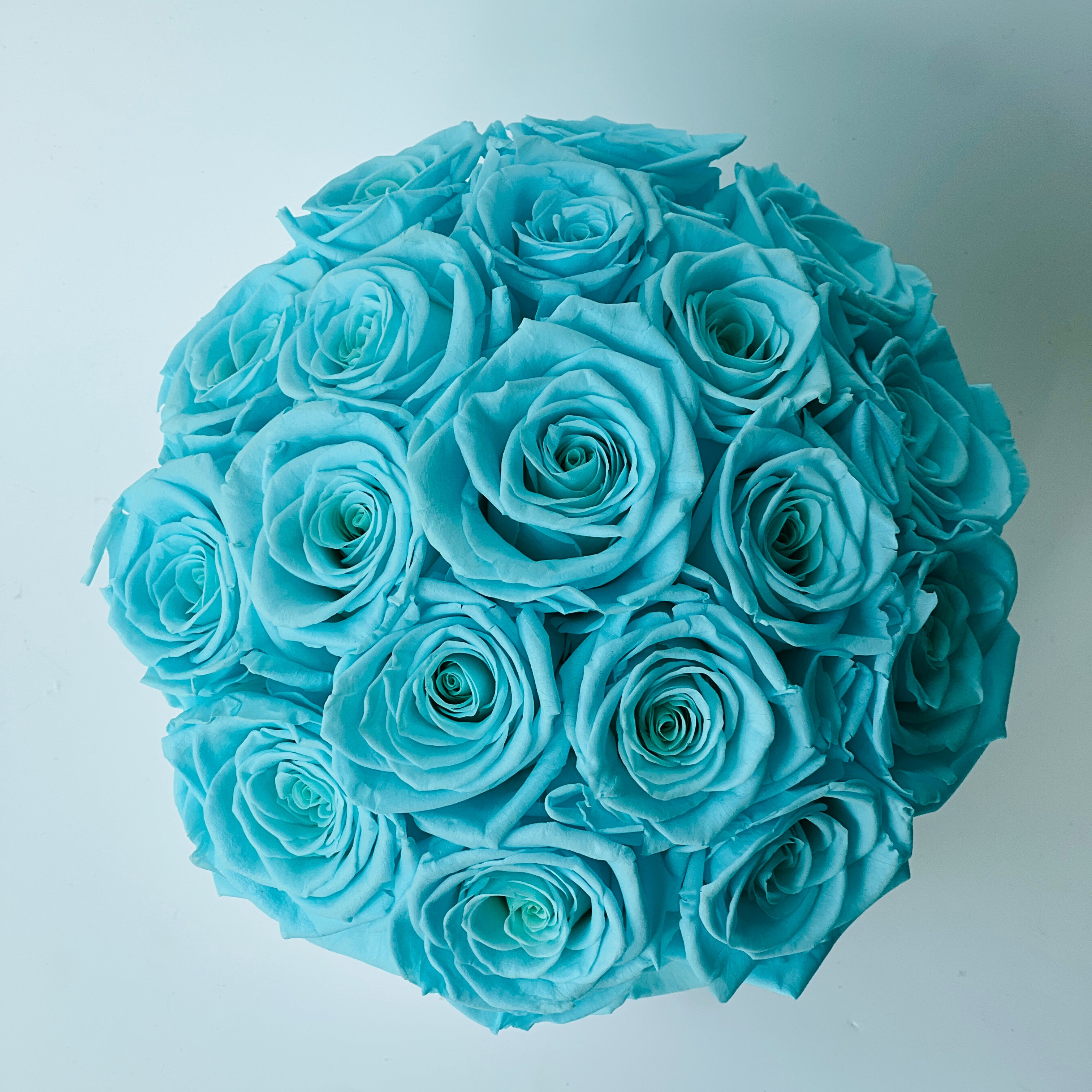 Preserved Tiffany Blue Rose Arrangement: Timeless beauty in soft blue hues. Expertly preserved blooms offer elegance without maintenance, perfect for any space or gift.