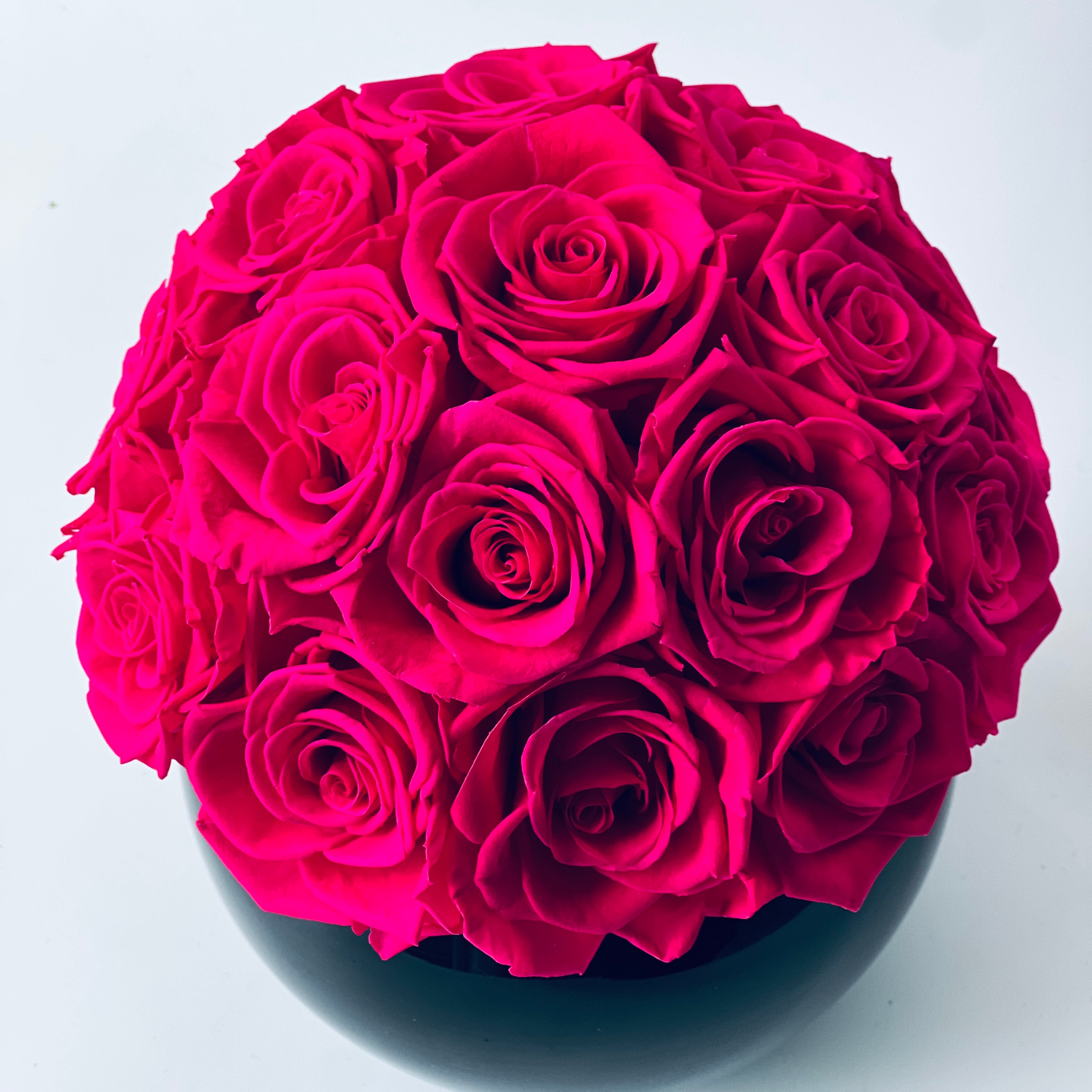 Hot Pink Roses in Black Vase: A bold sphere of preserved roses in a glossy black vase, offering a striking, maintenance-free touch of sophistication for any space.