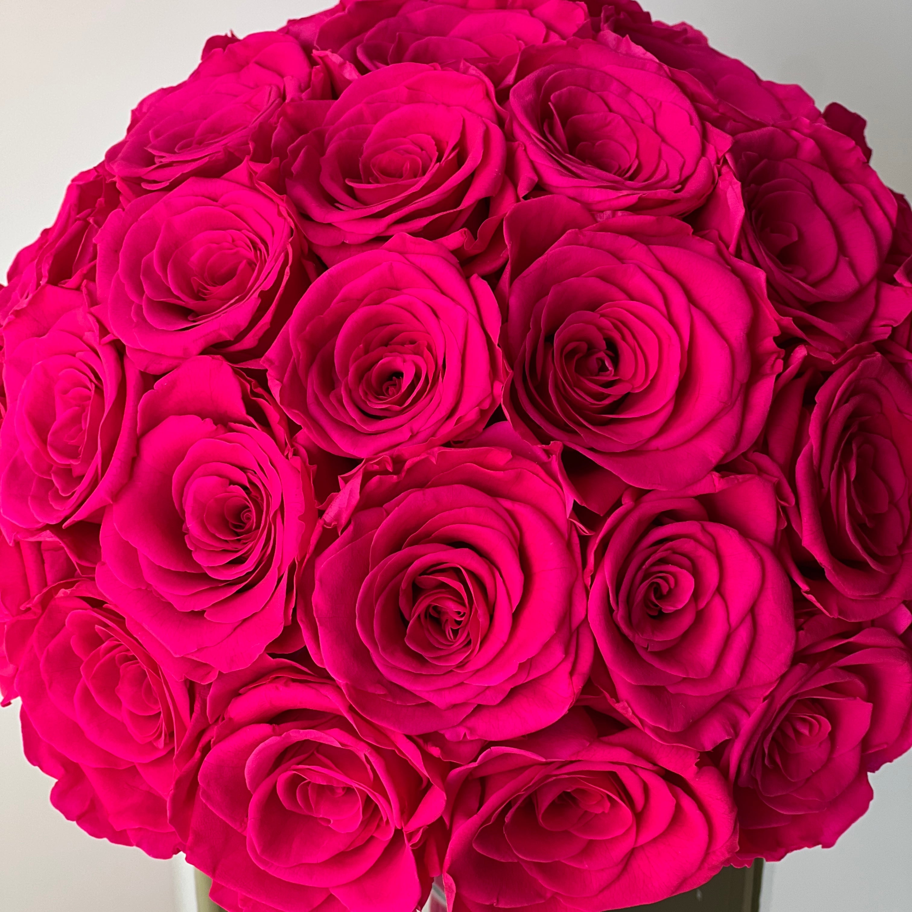 The Preserved Yellow Rose Arrangement showcases expertly preserved roses with a soft, vibrant hot pink hue and petal-perfect texture. This timeless eternity rose gift adds everlasting elegance to any space, making it perfect for special occasions like Valentine's Day or anniversaries.