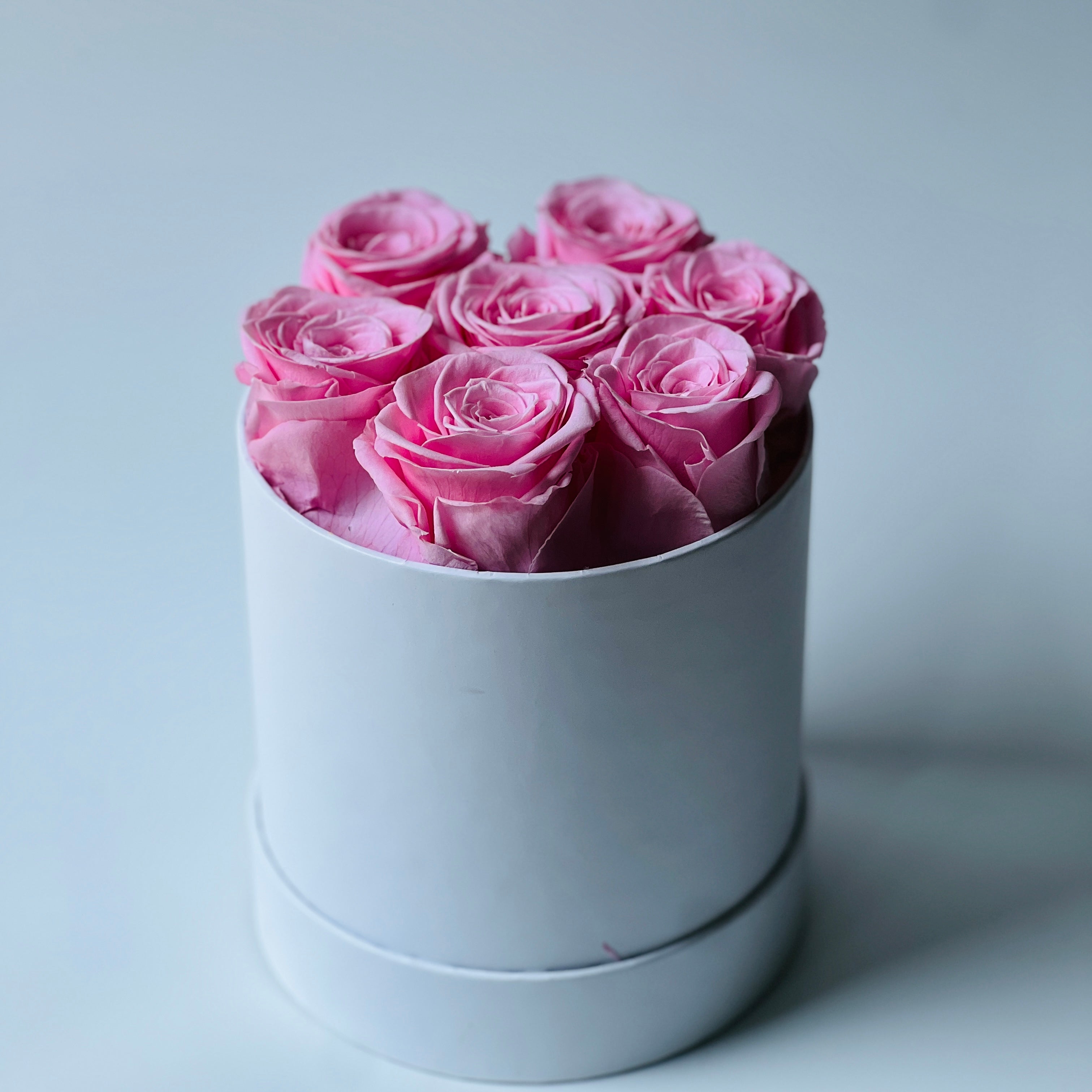 The Pink Elegance Box features a delightful collection of preserved soft pink roses, arranged in a sleek white box. This timeless eternity rose gift adds a touch of serenity and sophistication, perfect for special occasions or home décor.