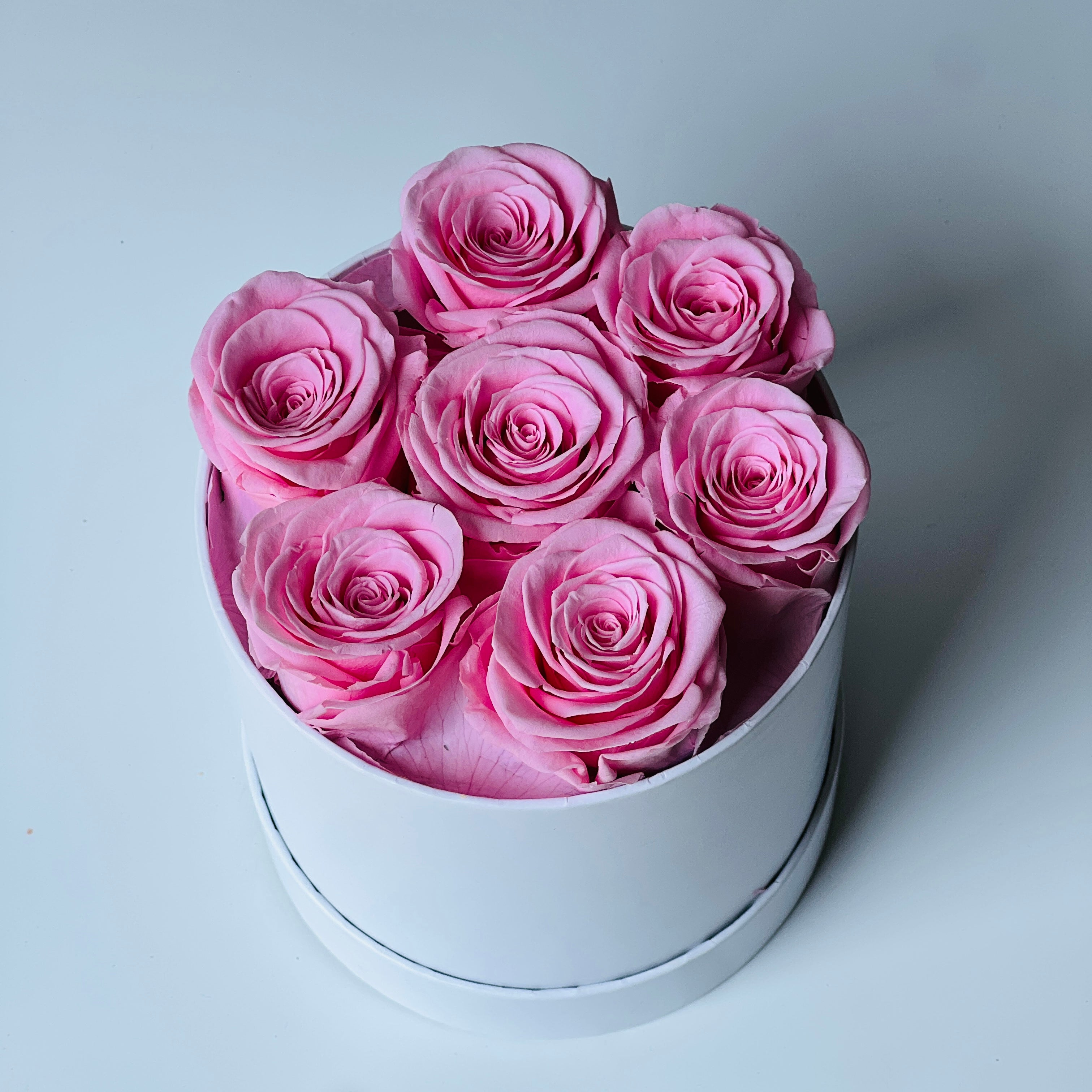 The Pink Elegance Box features a delightful collection of preserved soft pink roses, arranged in a sleek white box. This timeless eternity rose gift adds a touch of serenity and sophistication, perfect for special occasions or home décor.