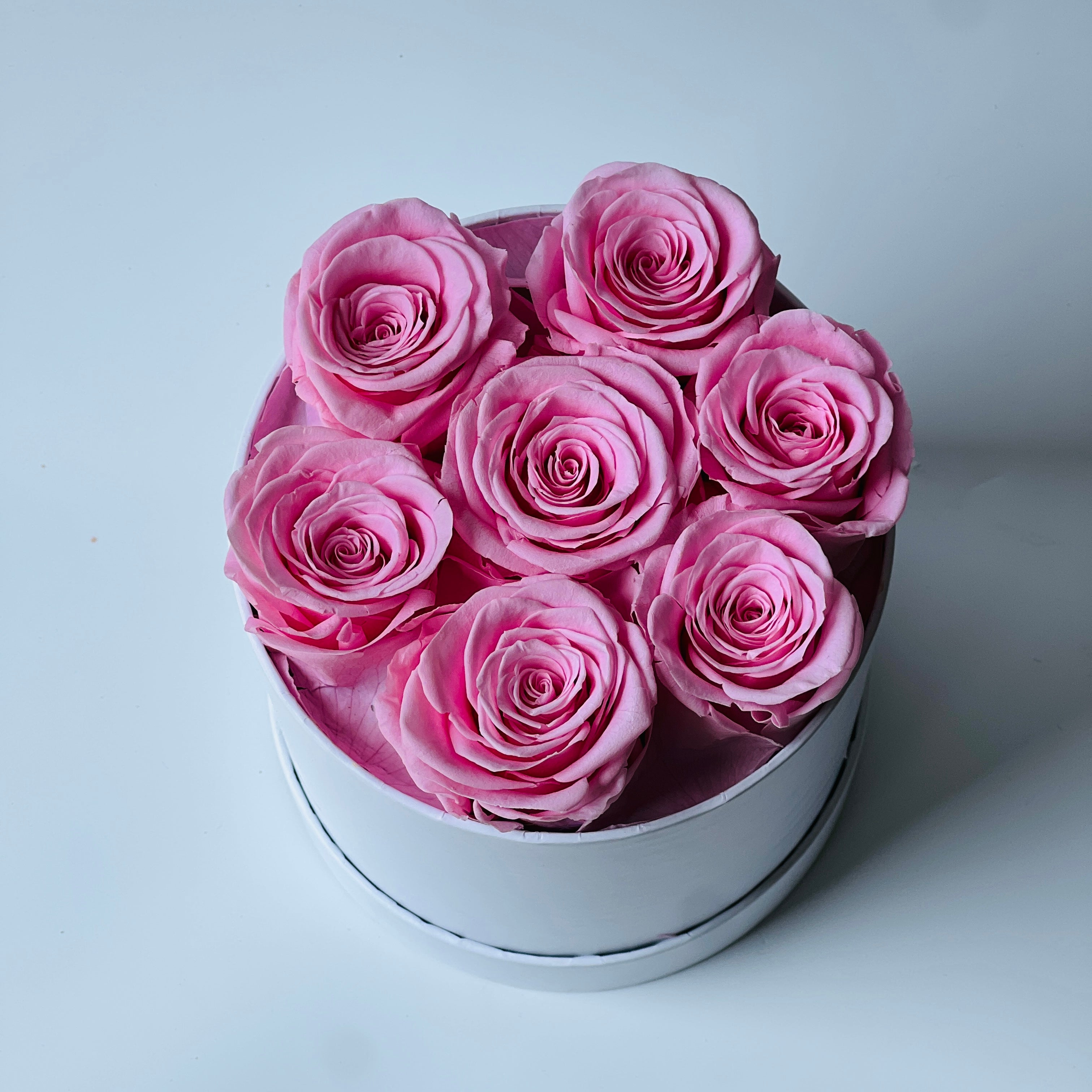 The Pink Elegance Box features a delightful collection of preserved soft pink roses, arranged in a sleek white box. This timeless eternity rose gift adds a touch of serenity and sophistication, perfect for special occasions or home décor.