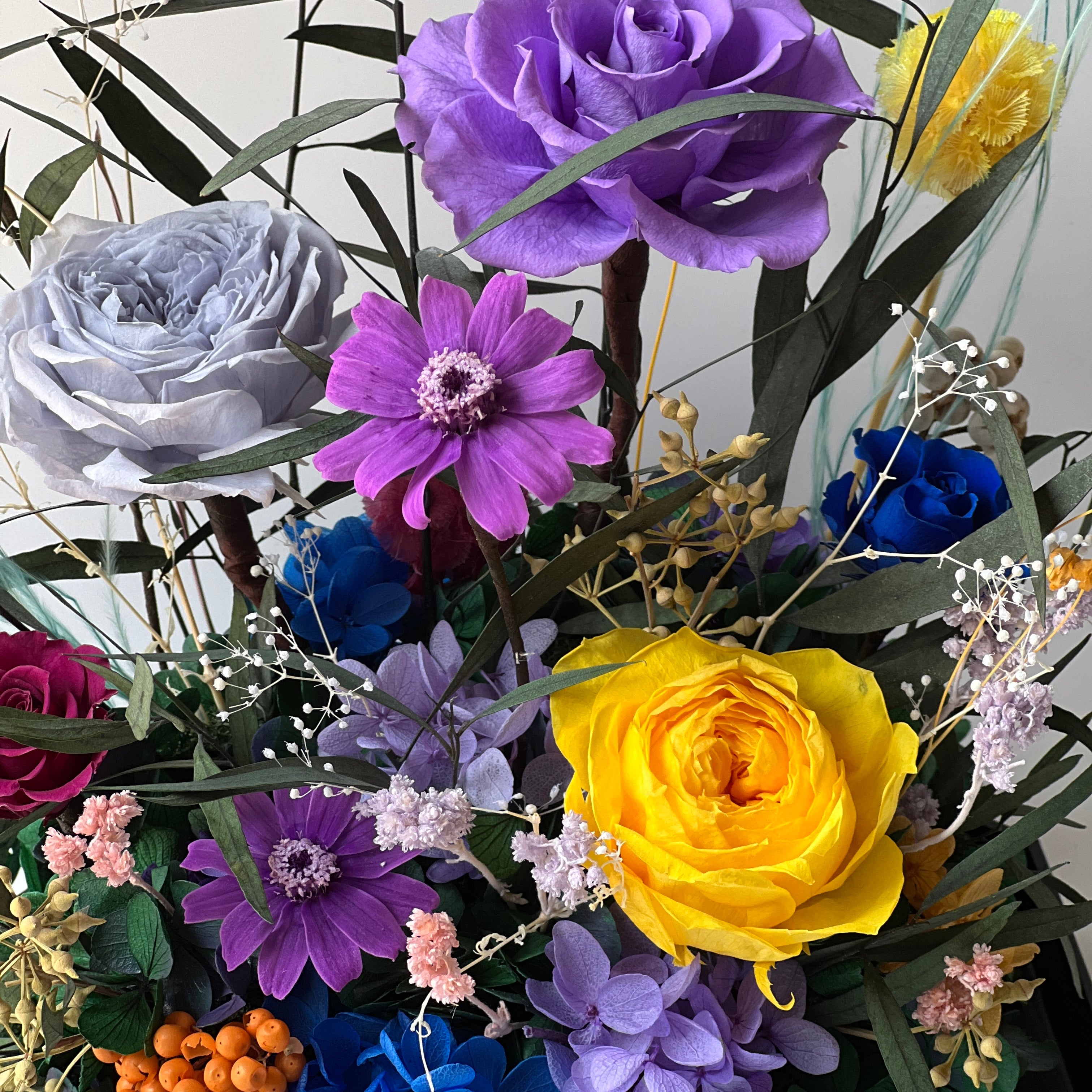 Mini Garden preserved flower arrangement featuring vibrant multi-color roses and delicate clematis in a sleek acrylic box. A thoughtful eternity rose gift perfect for brightening any space.