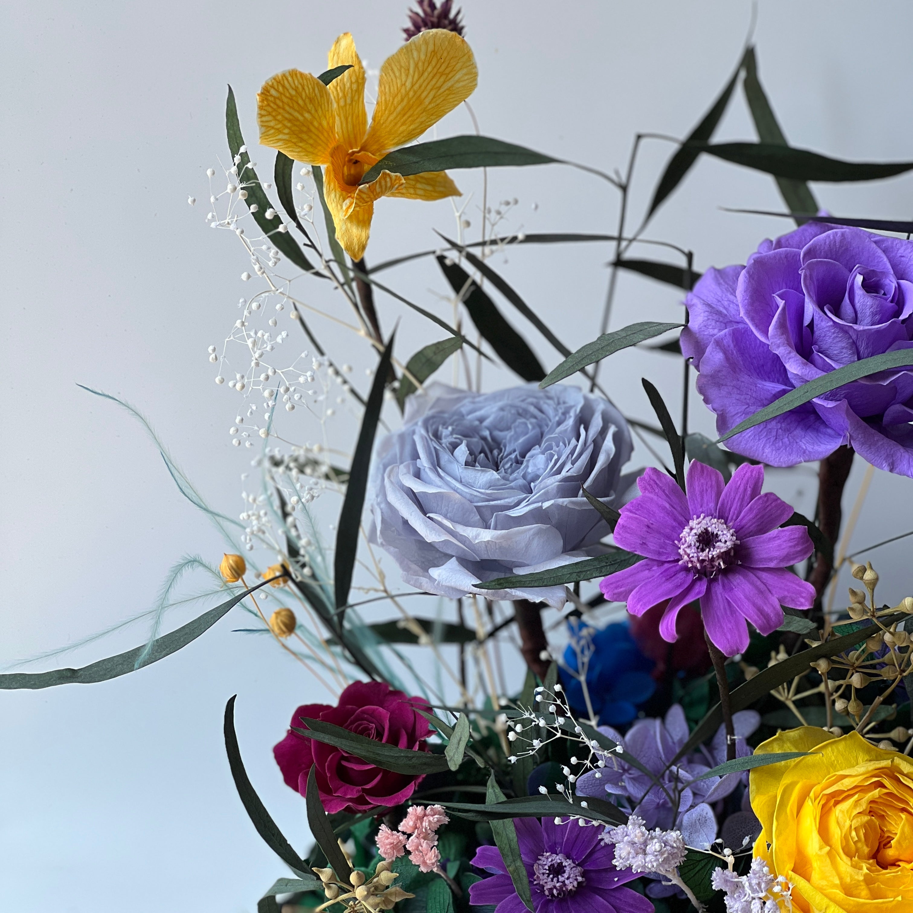 Mini Garden preserved flower arrangement featuring vibrant multi-color roses and delicate clematis in a sleek acrylic box. A thoughtful eternity rose gift perfect for brightening any space.