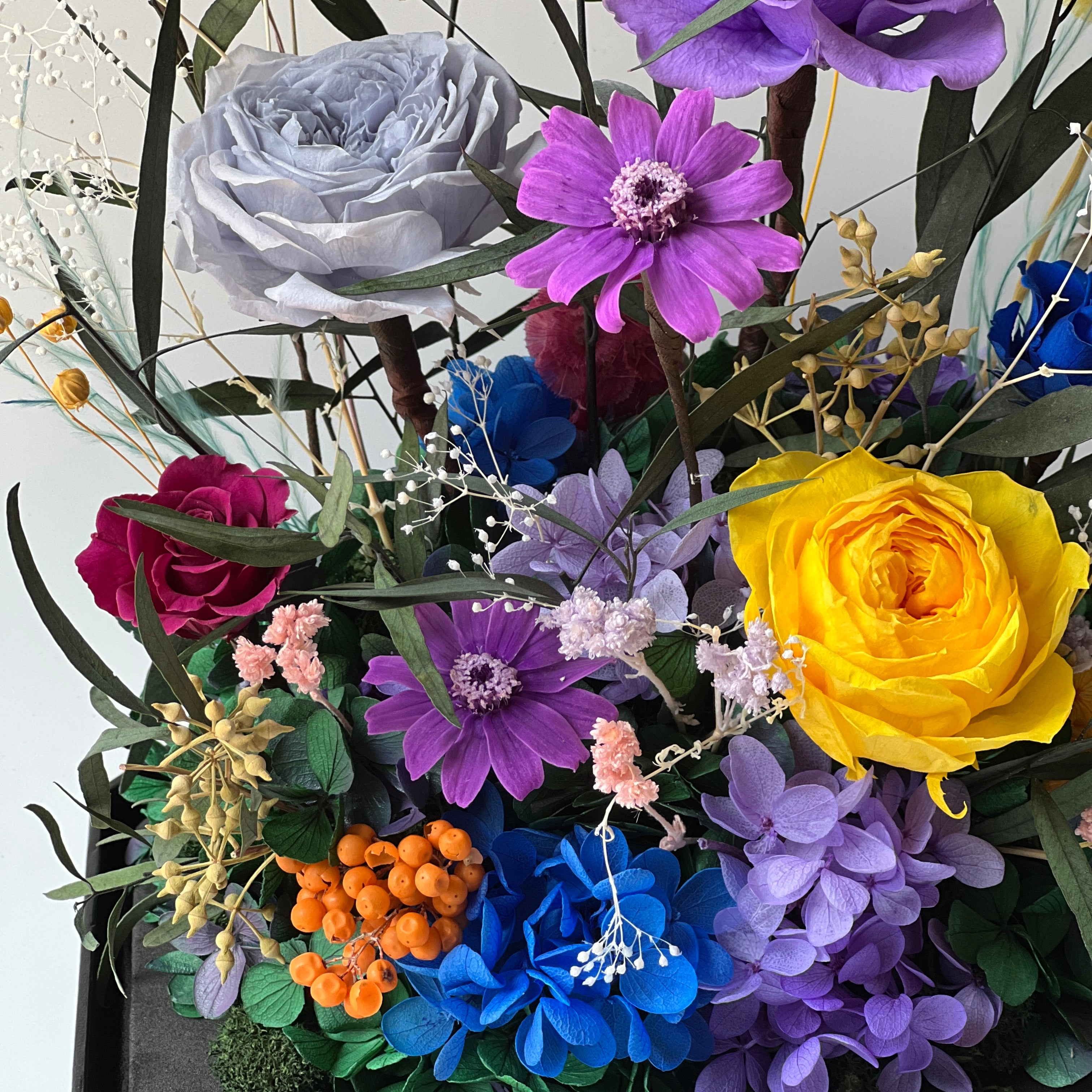 Mini Garden preserved flower arrangement featuring vibrant multi-color roses and delicate clematis in a sleek acrylic box. A thoughtful eternity rose gift perfect for brightening any space.