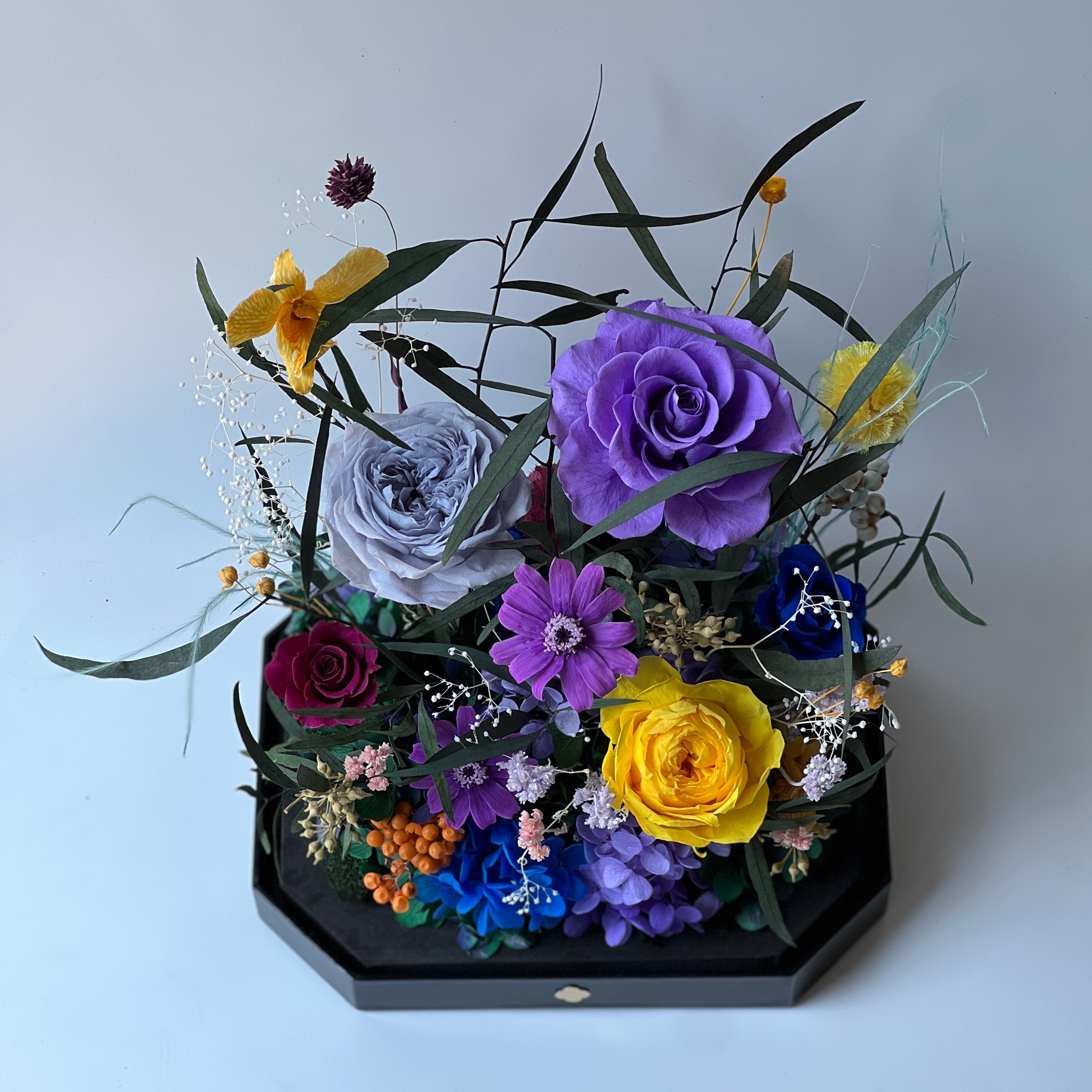 Mini Garden preserved flower arrangement featuring vibrant multi-color roses and delicate clematis in a sleek acrylic box. A thoughtful eternity rose gift perfect for brightening any space.