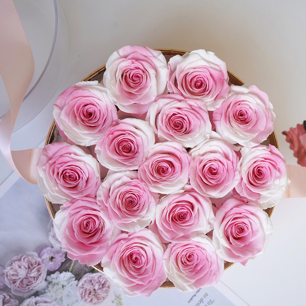 Stunning floral box featuring 16 long-stemmed preserved roses, available in multiple colors, elegantly arranged in a round box. A perfect eternity rose gift for birthdays, anniversaries, or Valentine's Day.