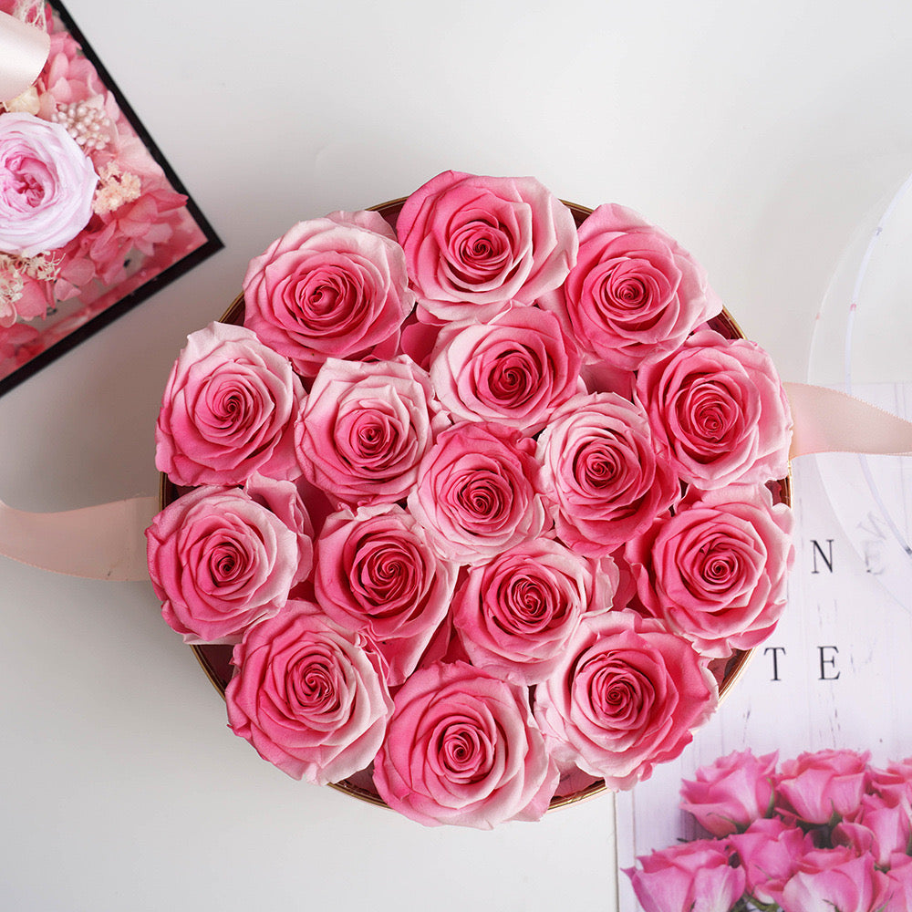 Stunning floral box featuring 16 long-stemmed preserved roses, available in multiple colors, elegantly arranged in a round box. A perfect eternity rose gift for birthdays, anniversaries, or Valentine's Day.