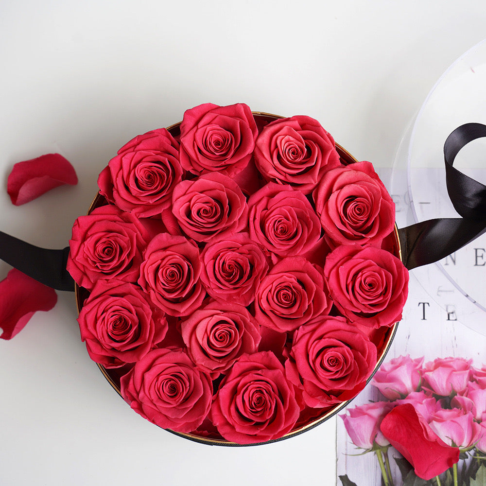 Stunning floral box featuring 16 long-stemmed preserved roses, available in multiple colors, elegantly arranged in a round box. A perfect eternity rose gift for birthdays, anniversaries, or Valentine's Day.