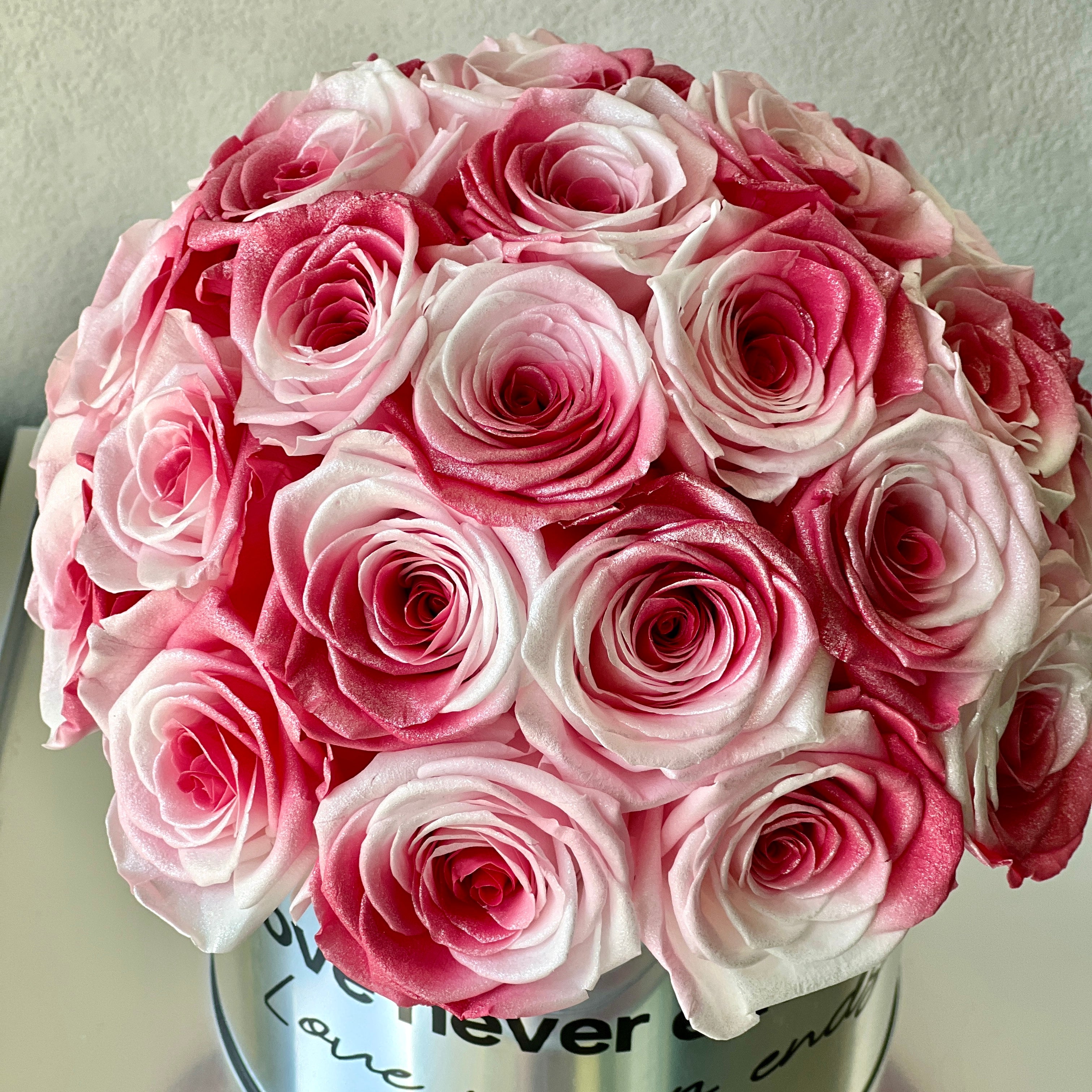 Stunning floral hat box featuring over two dozen preserved white to pink gradient roses, perfect for adding romance and elegance to any space. An ideal eternity rose gift for special occasions like Valentine's Day or anniversaries.