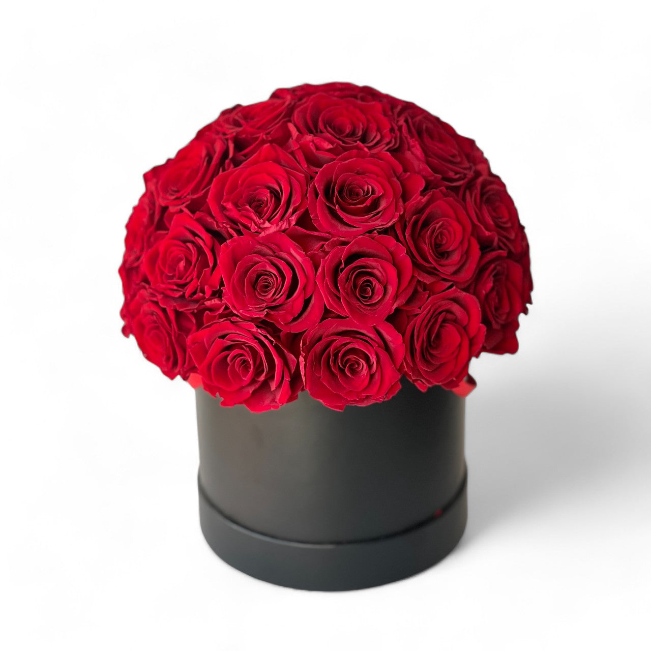 Elegant Medium Round Rose Hat Box featuring 33-35 preserved red roses in a sleek black hatbox, offering a timeless centerpiece perfect for gifting or decorating any space.