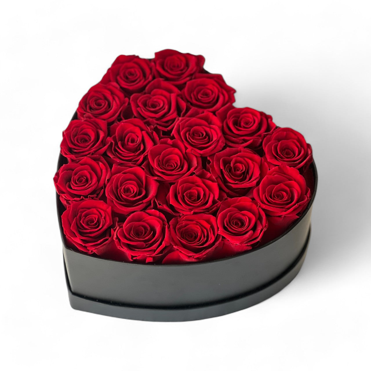 The Heart Hat Box With Roses features 20 Ecuadorian eternity red roses arranged in a black heart-shaped hatbox. This elegant and timeless rose gift lasts for 3-7 years, perfect for expressing love or adding a touch of sophistication to any space.