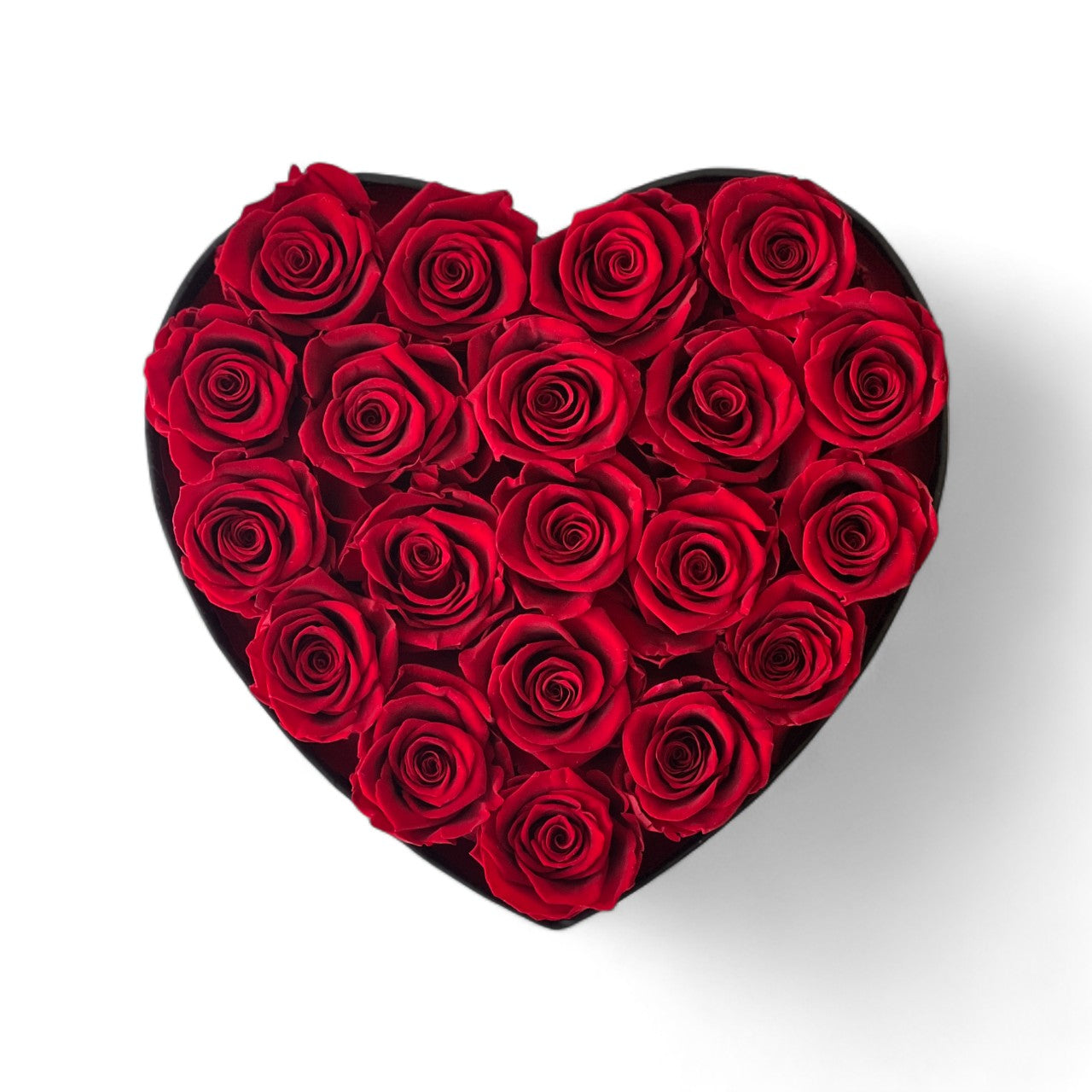 The Heart Hat Box With Roses features 20 Ecuadorian eternity red roses arranged in a black heart-shaped hatbox. This elegant and timeless rose gift lasts for 3-5 years, perfect for expressing love or adding a touch of sophistication to any space.