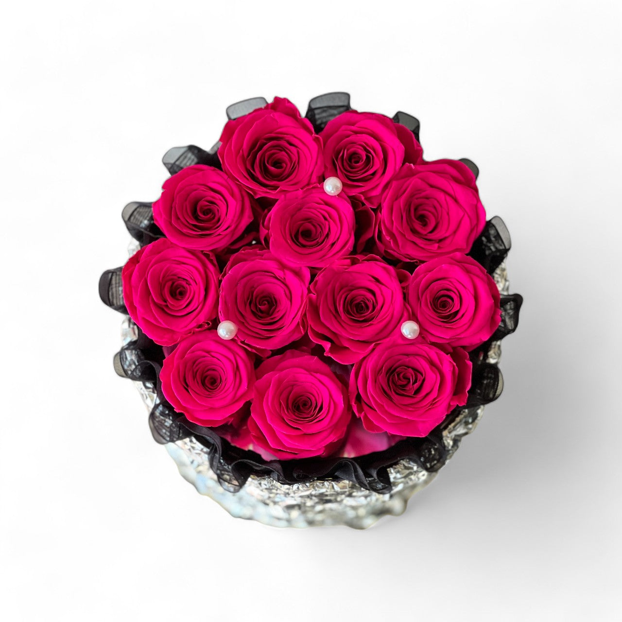 Romantic floral arrangement featuring vibrant preserved hot pink roses, perfect for surprising your sweetheart with a gesture of love. An exquisite eternity rose gift for special occasions like Valentine's Day or anniversaries.