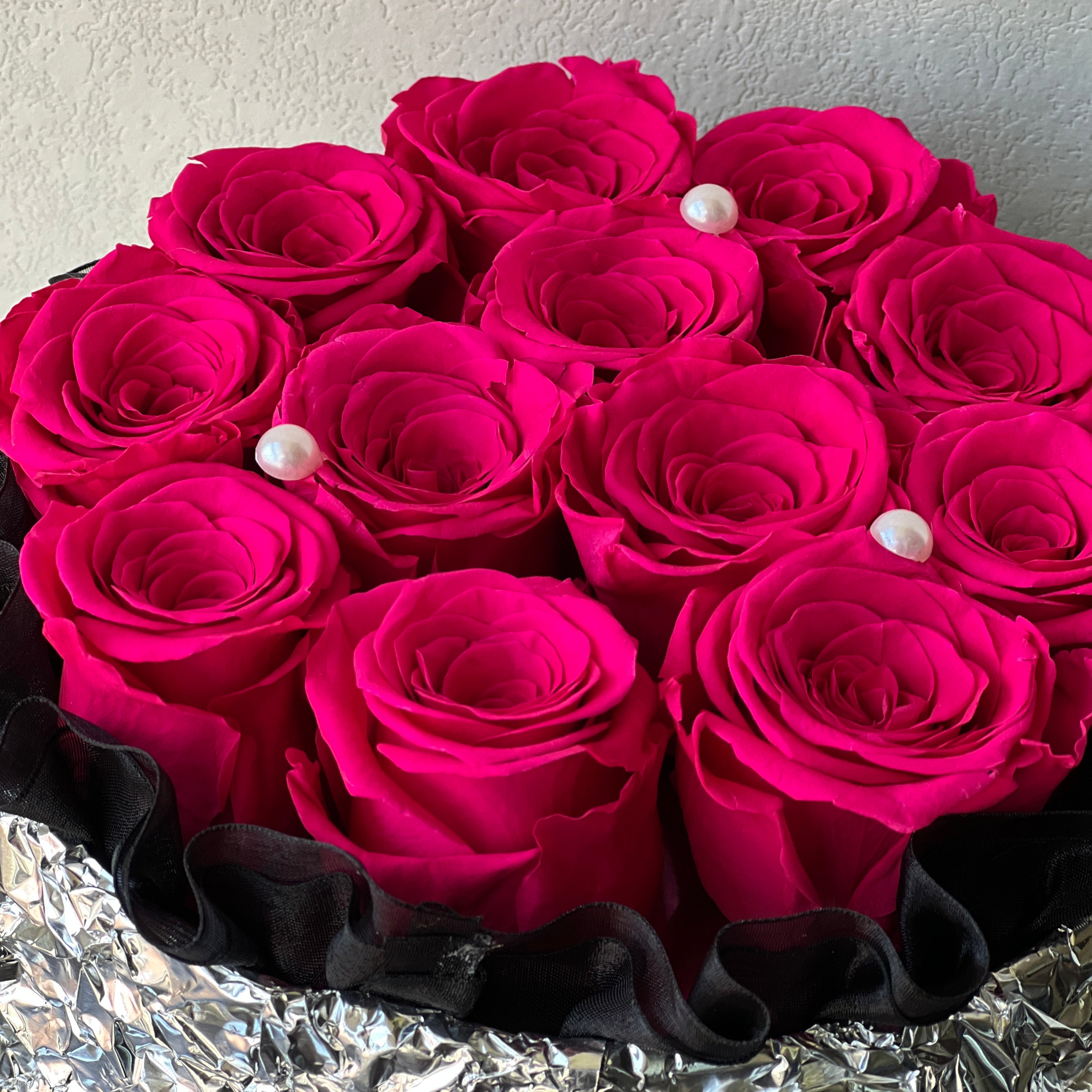 Romantic floral arrangement featuring vibrant preserved hot pink roses, perfect for surprising your sweetheart with a gesture of love. An exquisite eternity rose gift for special occasions like Valentine's Day or anniversaries.