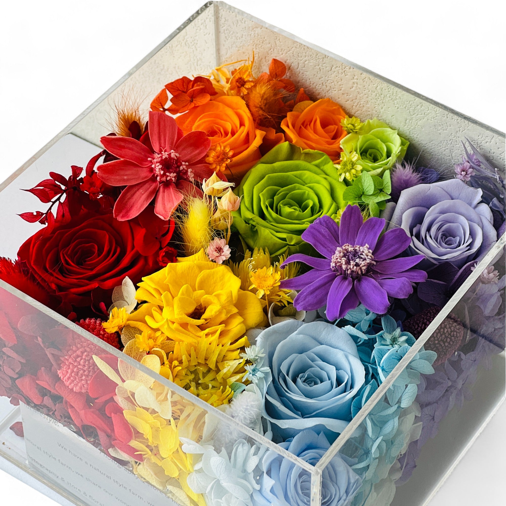 The Rainbow Floral Box features preserved roses, clematis, and hydrangeas in a vibrant, multicolor arrangement. A stunning eternity flower gift perfect for bringing romance to life on any special occasion.