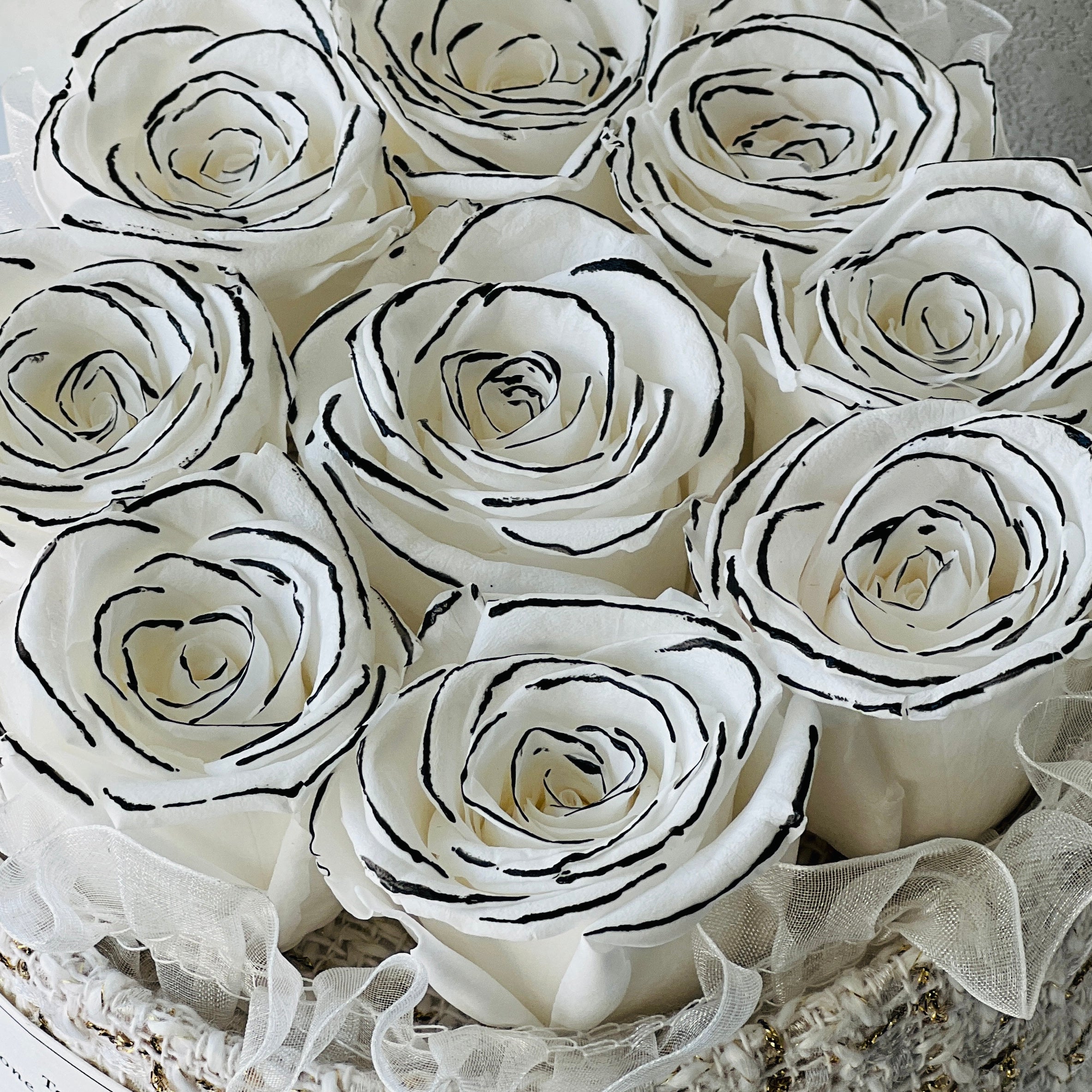 Signature Rose Basket featuring 11 preserved white roses elegantly arranged in a classic woven basket. A luxurious eternity rose gift perfect for adding grace to any space or gifting on special occasions.