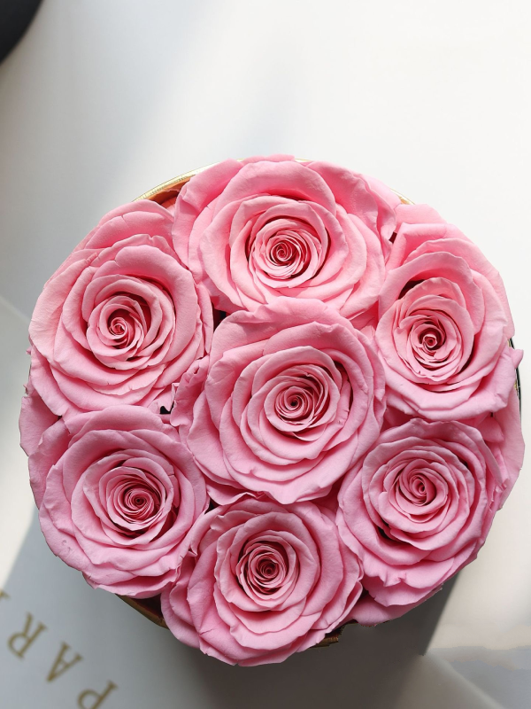 Round Floral Box with preserved roses in shades of white, pink, blue, and more, elegantly displayed in a round glass box. A timeless eternity rose gift perfect for home decor or gifting on special occasions.