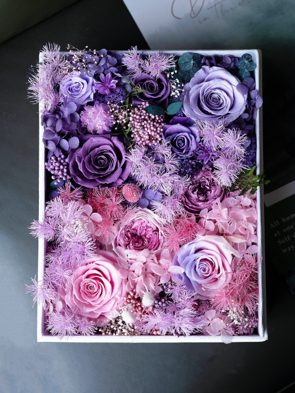 Framed Preserved Flower Box with multi-color roses and seasonal blooms, elegantly displayed in a wooden frame. Perfect decor or gift for nature lovers. Size: 8''x10''x5''.