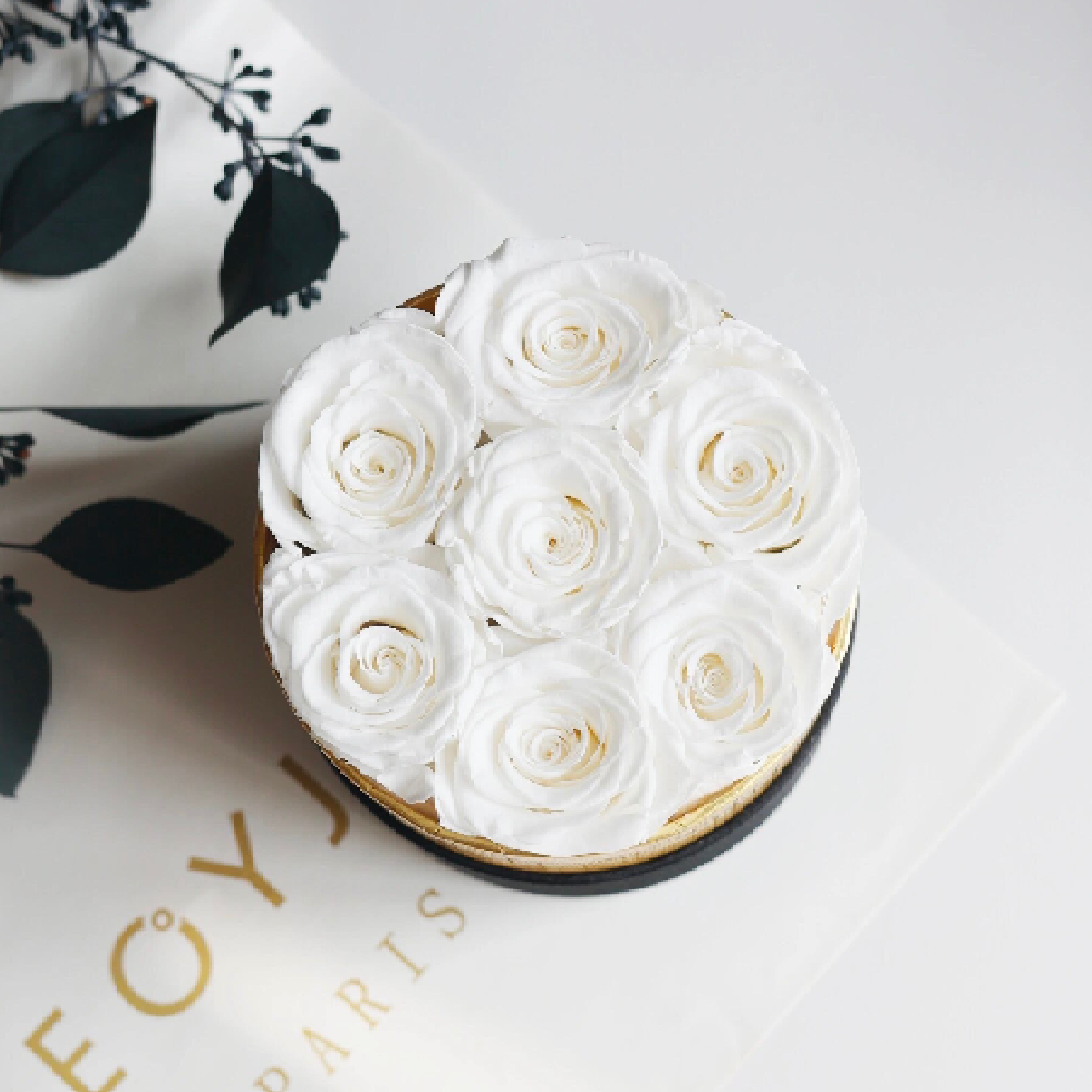 Round Floral Box with preserved roses in shades of white, pink, blue, and more, elegantly displayed in a round glass box. A timeless eternity rose gift perfect for home decor or gifting on special occasions.