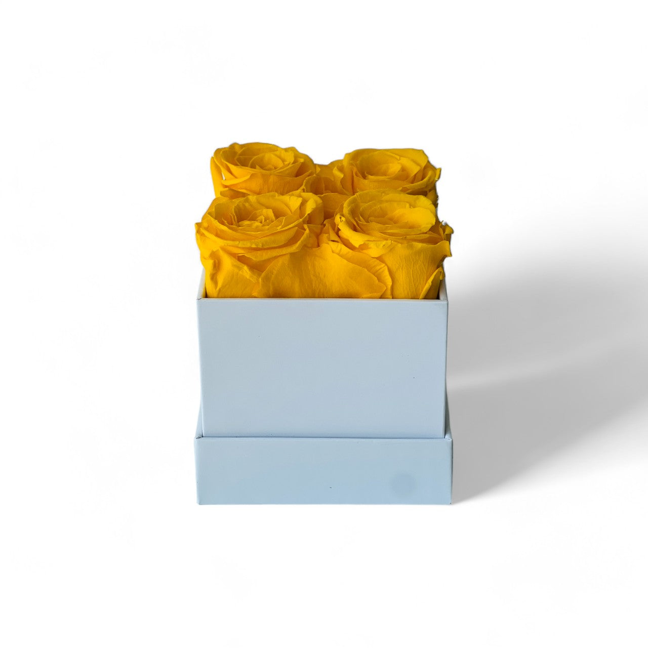 The Sunshine Roses arrangement features vibrant yellow preserved roses in a minimalist white box, offering a burst of joy and lasting beauty. This cheerful eternity rose gift is perfect for brightening any space or as a thoughtful gesture for any occasion.