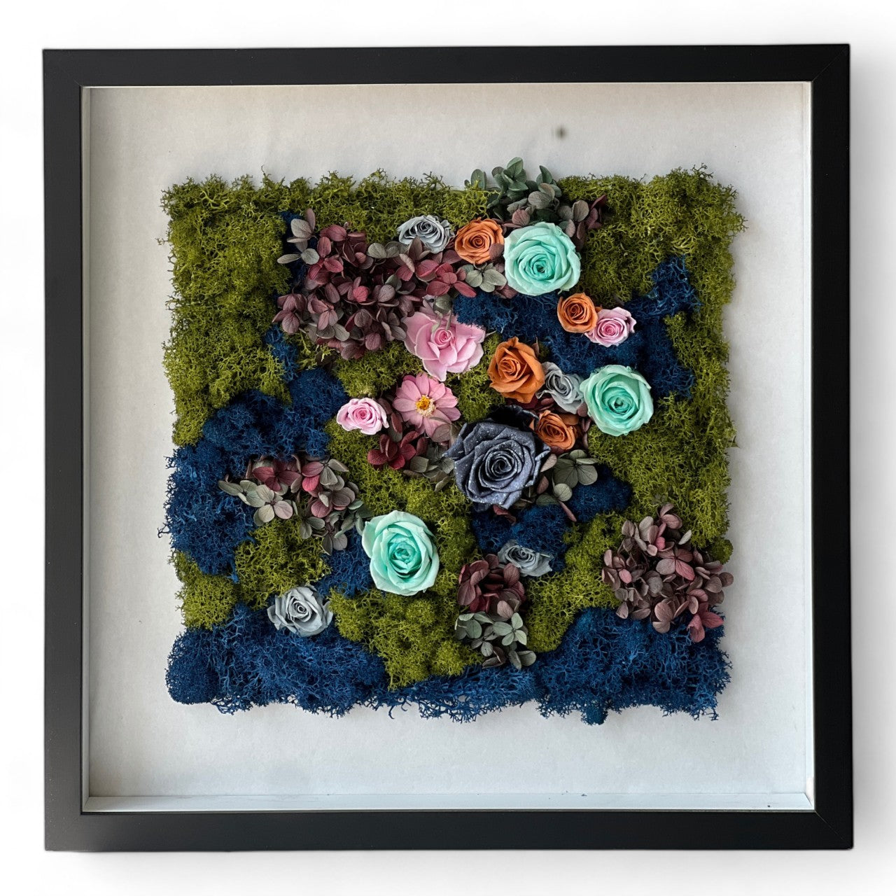 The preserved flower display inspired by Monet's secret garden, with roses and hydrangeas in vivid hues, adds serene beauty to any home or office.