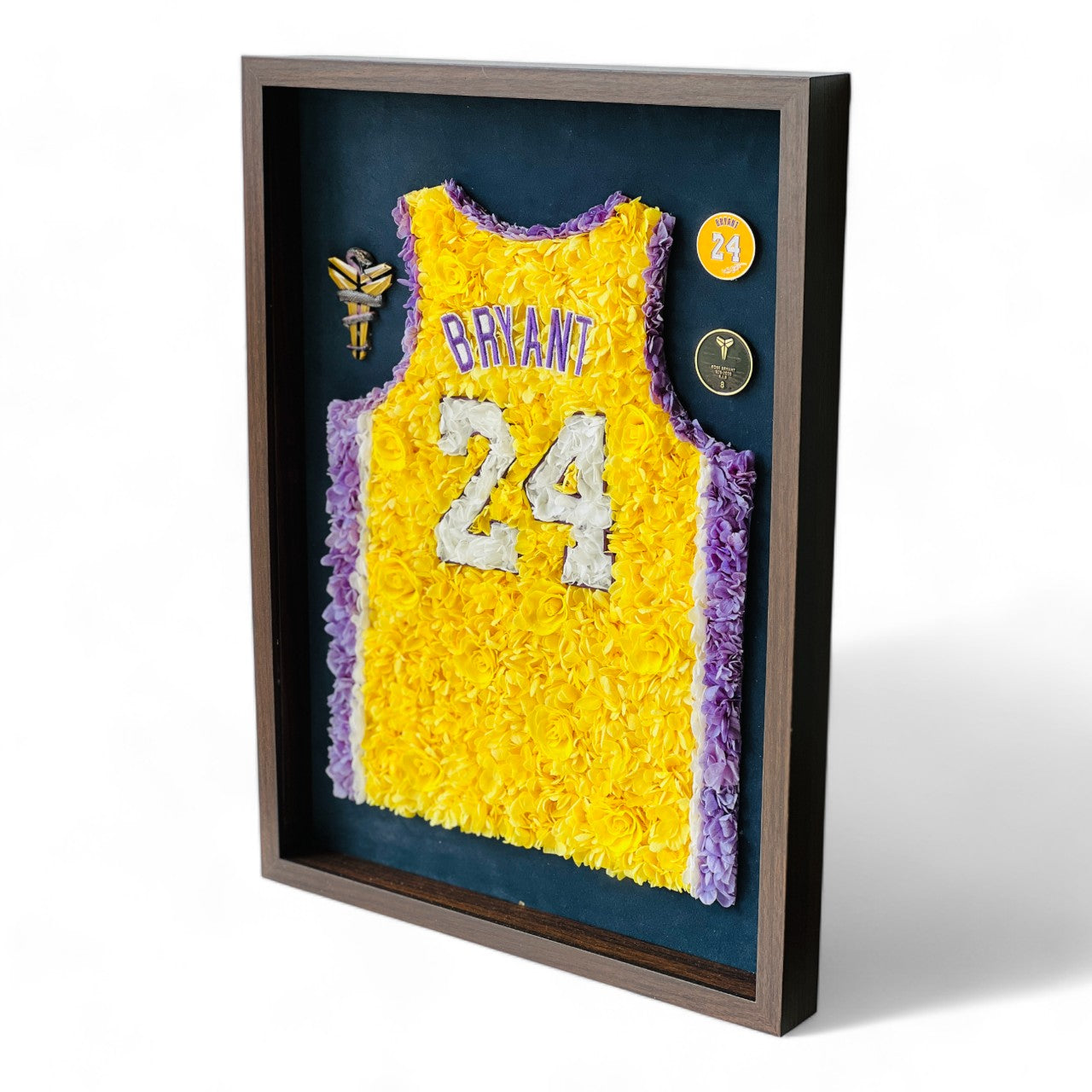 Preserved floral tribute to Kobe Bryant's iconic number 24 jersey, featuring roses and hydrangeas in yellow and purple, framed in dark wood. A perfect piece for collectors and enthusiasts.