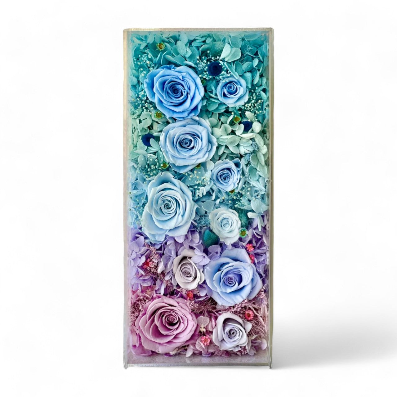 The Enchanted Rose Symphony features a mesmerizing gradient of preserved roses and hydrangeas, transitioning from soft blush pink to tiffany blue. A captivating eternity flower centerpiece for any space.