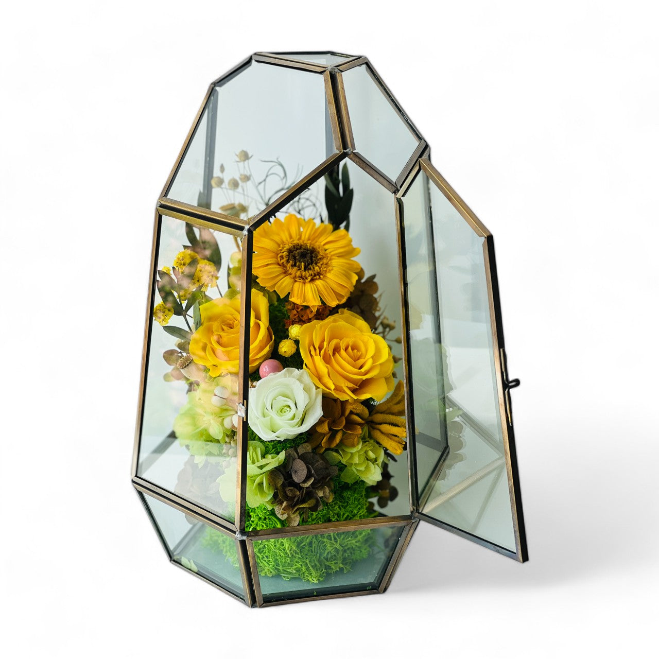 Sunshine and Serenity preserved floral arrangement featuring sunny yellow roses, a cheerful sunflower, and delicate white roses in a geometric acrylic terrarium. A perfect eternity rose gift to brighten any space.