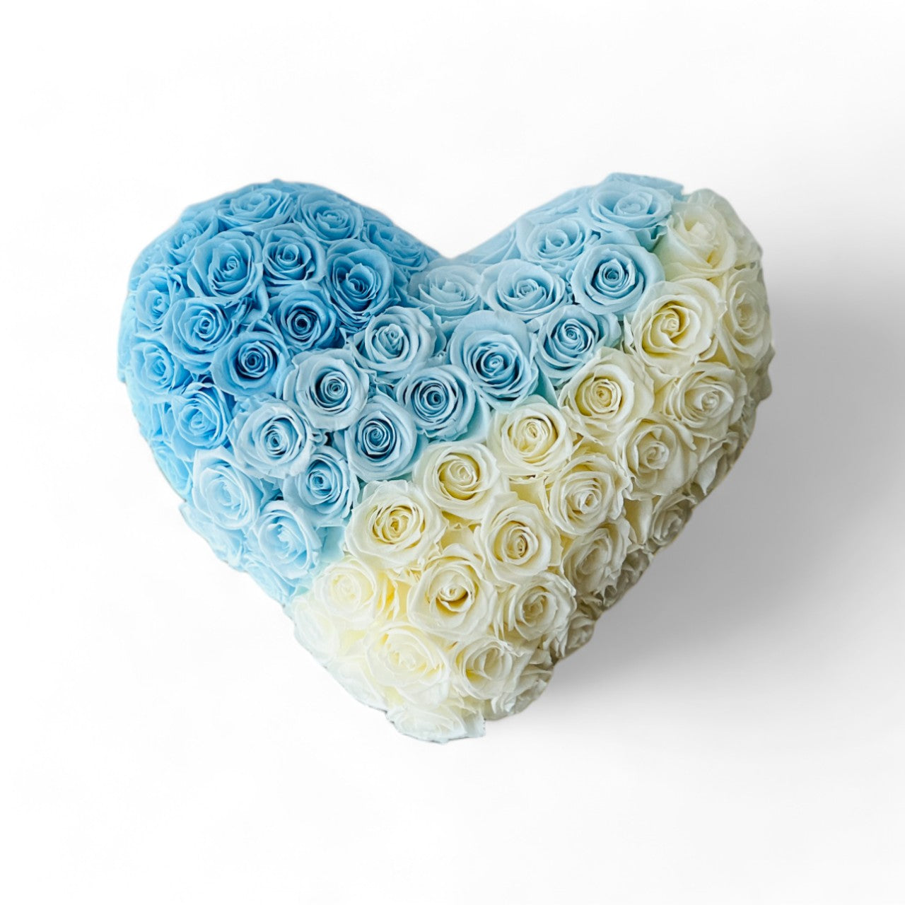 Heart-shaped arrangement of preserved roses in serene blue and white, symbolizing peaceful emotions. Perfect as a timeless eternity rose gift for special occasions.