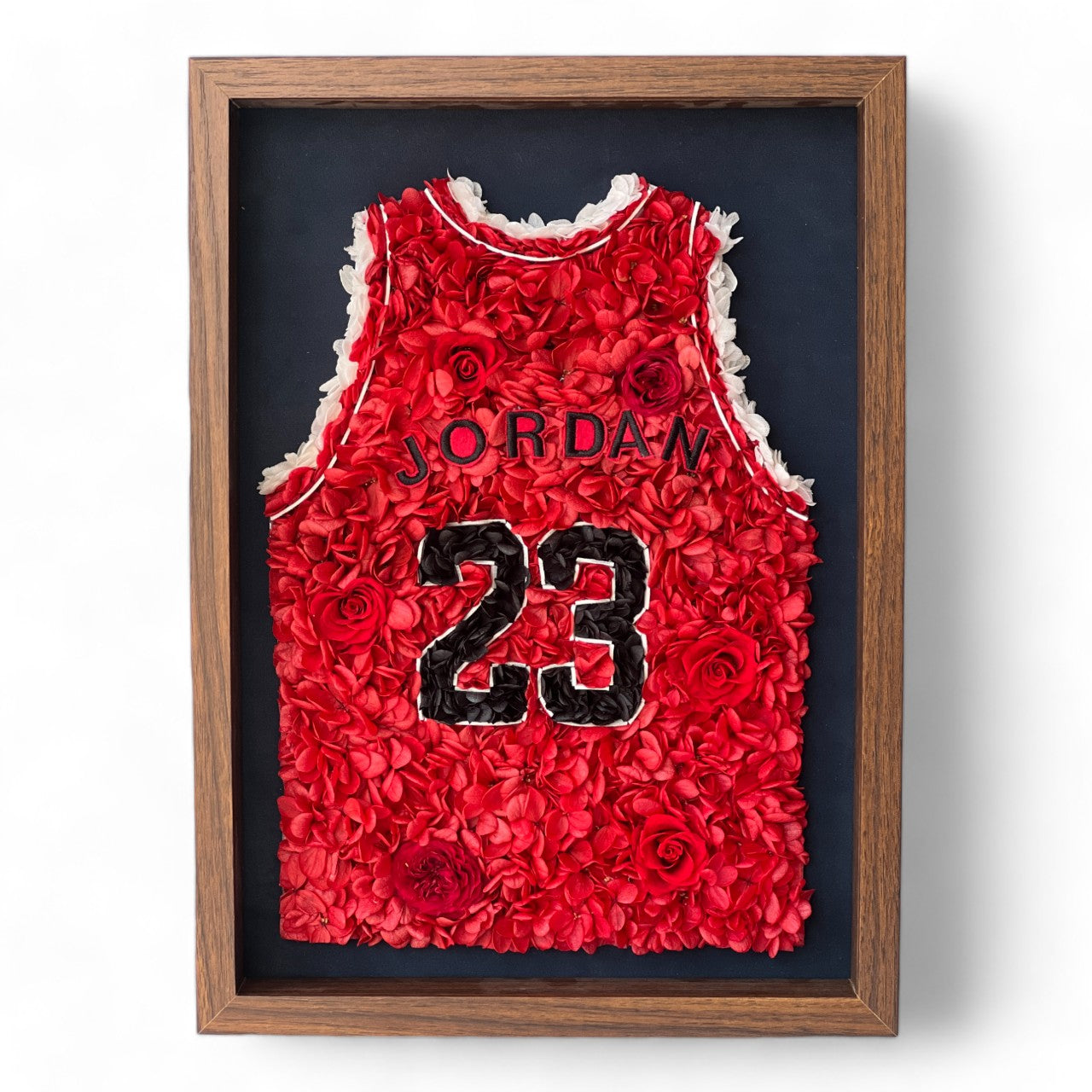 Preserved floral artwork inspired by Michael Jordan's iconic red jersey, featuring roses and hydrangeas. Perfect for sports fans and collectors, adding a bold, botanical touch.