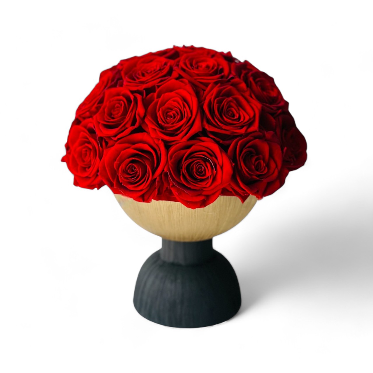 Elegant preserved red roses arranged on a two-tone pedestal vase. Maintenance-free and perfect as a dramatic centerpiece or memorable gift.