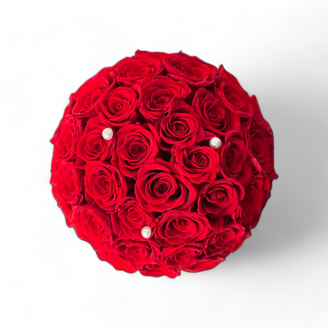 The Red Rose Dome features preserved red roses elegantly arranged atop a chic white hatbox, adorned with a pearl accent. This timeless eternity rose gift is perfect for expressing lasting love and adding a touch of class to any decor.