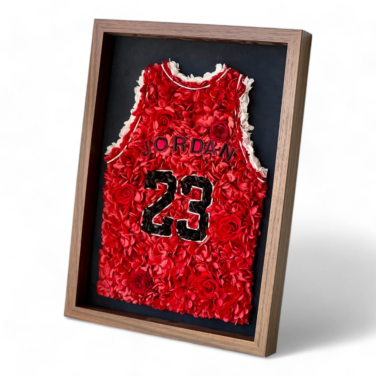 Preserved floral artwork inspired by Michael Jordan's iconic red jersey, featuring roses and hydrangeas. Perfect for sports fans and collectors, adding a bold, botanical touch.