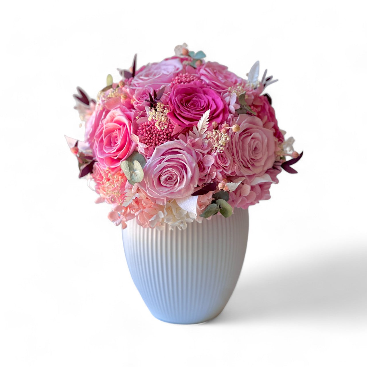 Radiant Rosé Bouquet featuring preserved pink roses, hydrangeas, and baby's breath, accented with greenery in a modern vase. Adds timeless charm and luxury to any space, maintenance-free for lasting beauty. Perfect as a thoughtful gift or elegant decor piece.