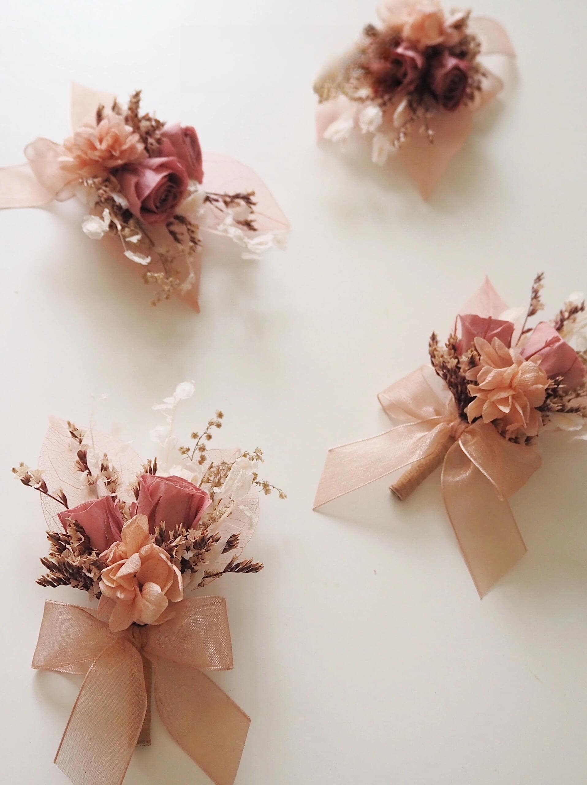 Dusty rose and peach wedding boutonniere with real preserved flowers
