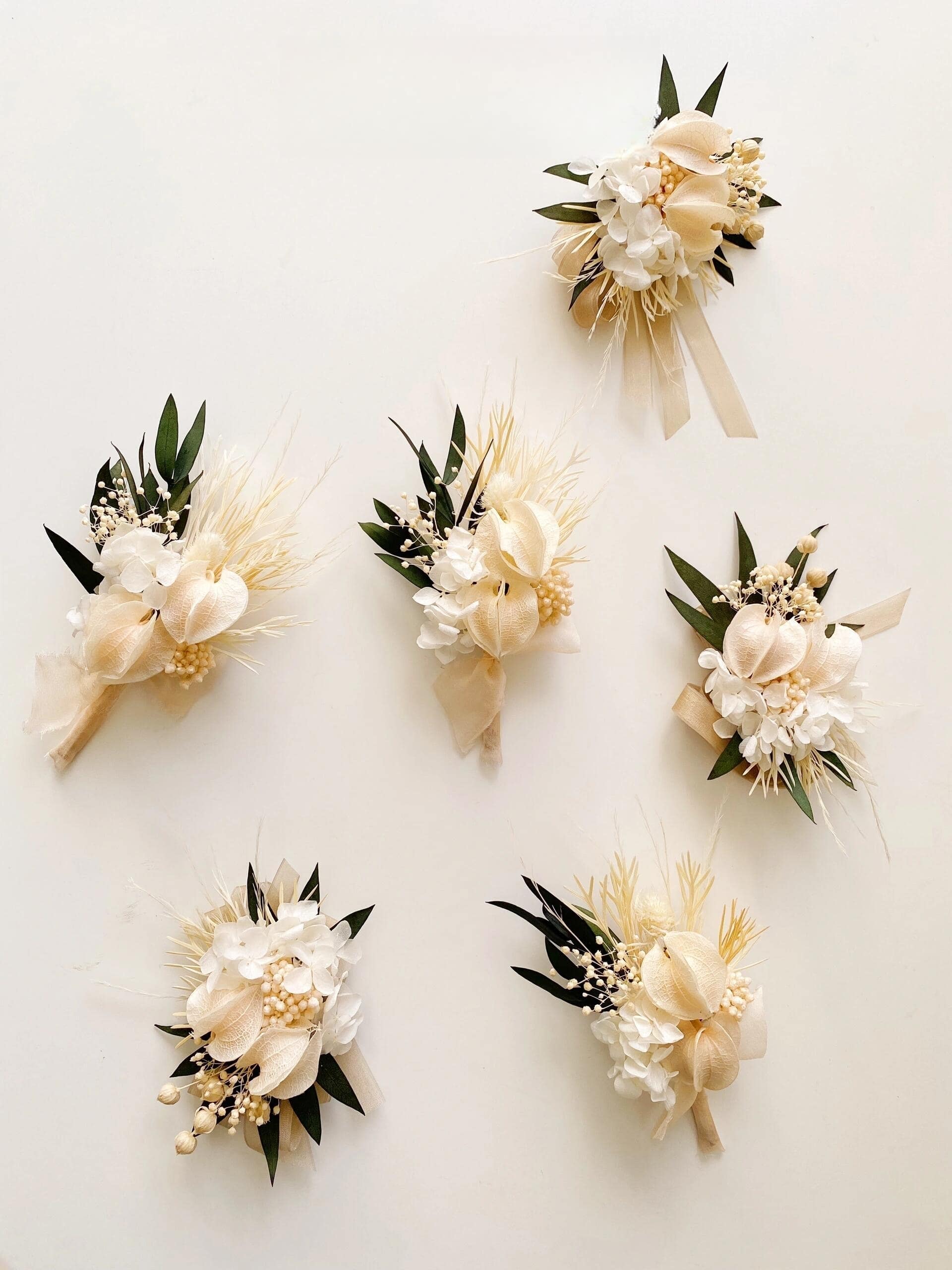 Wedding wrist corsage with preserved ivory calla lilies and white flowers
