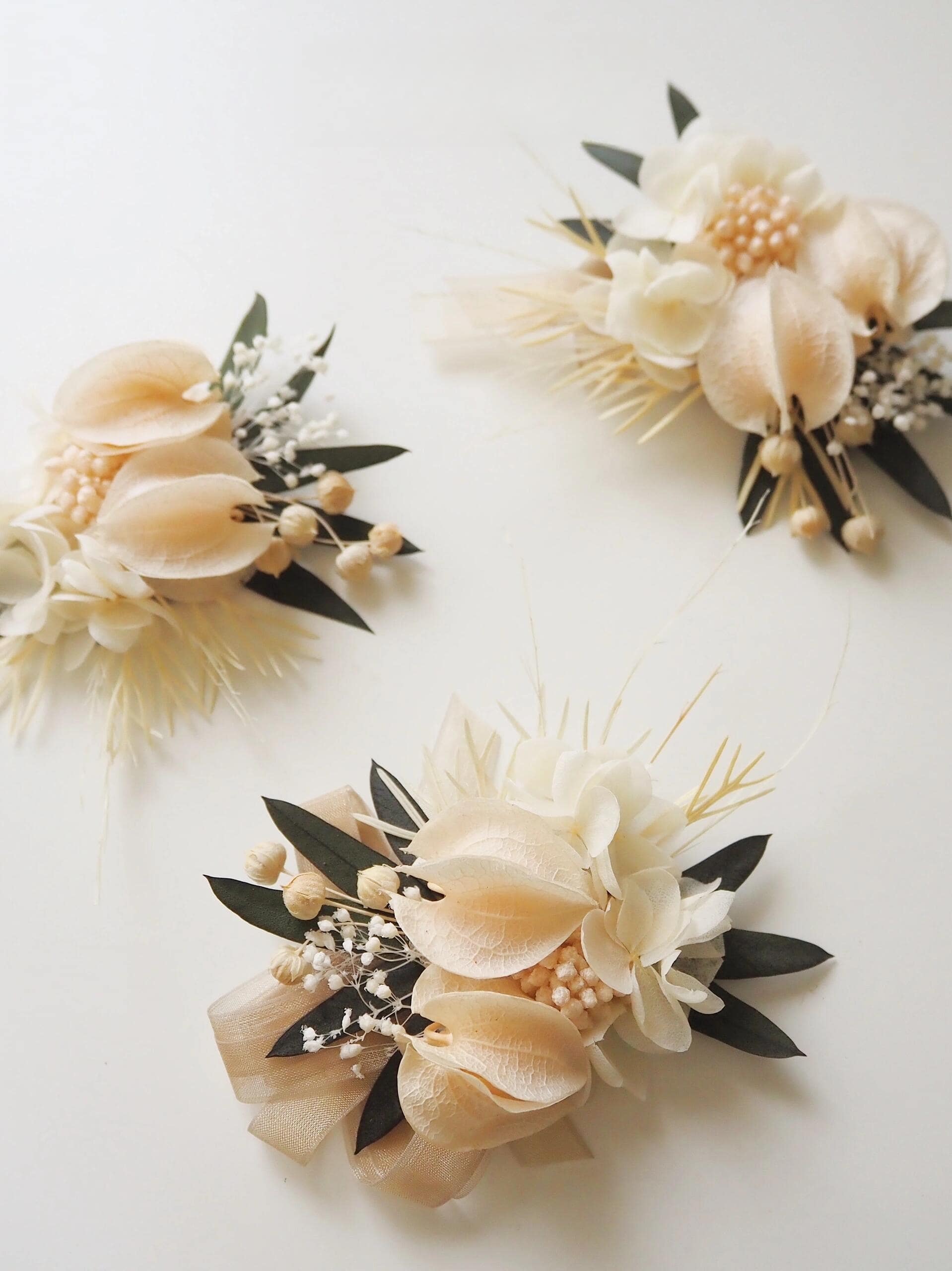 Wedding corsage with preserved ivory calla lilies and soft greenery
