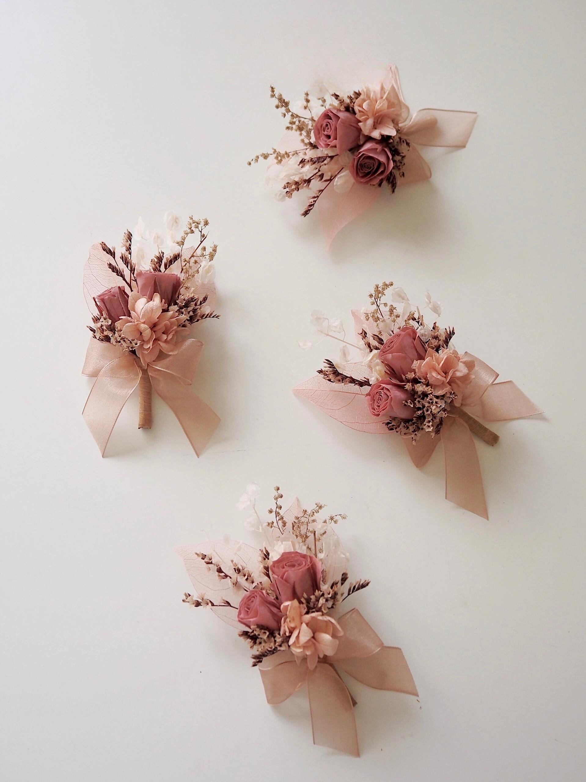 Romantic preserved flower boutonniere with dusty rose and peach tones
