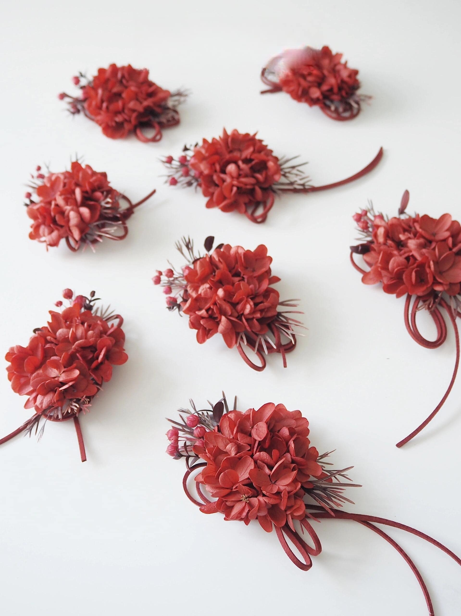 Deep red hydrangea and berry preserved flower corsage for weddings
