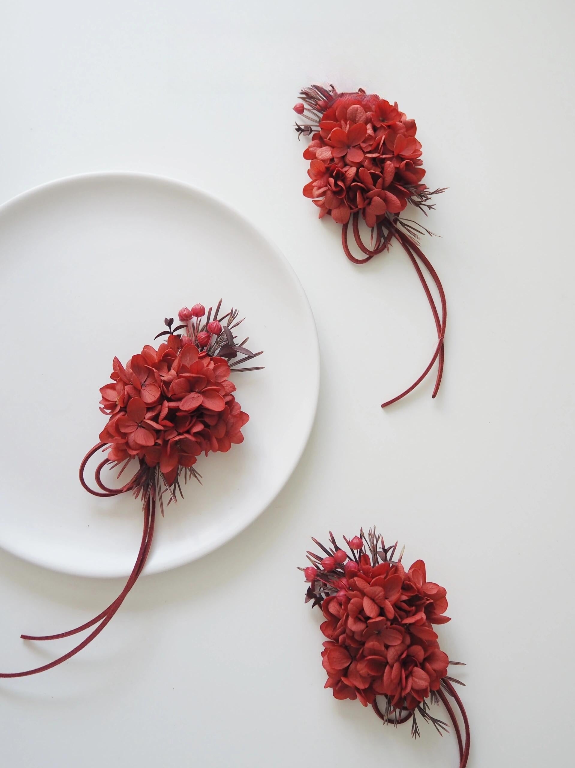 Deep red hydrangea and berry preserved flower corsage for weddings
