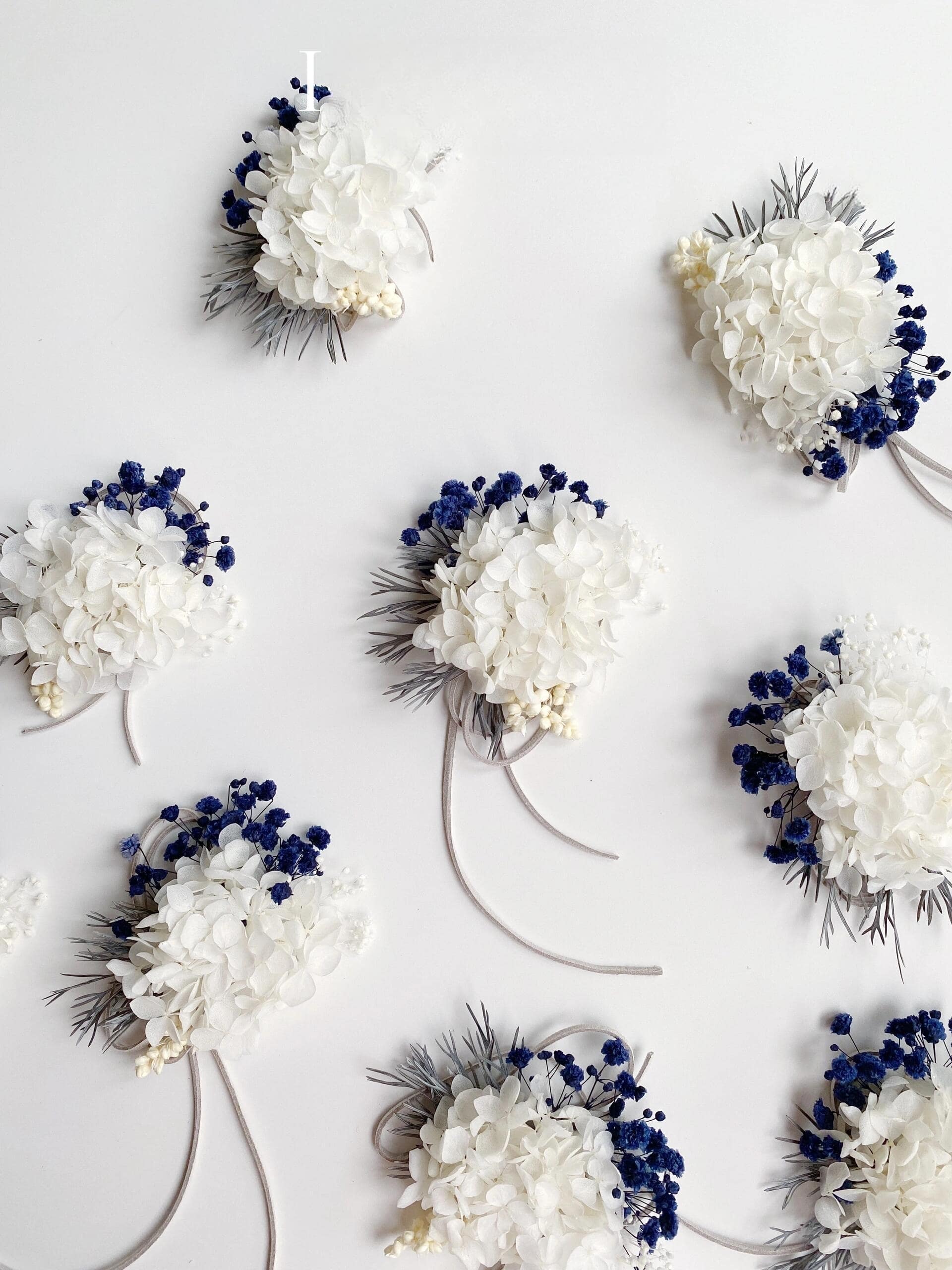 White hydrangea and blue statice preserved flower corsage
