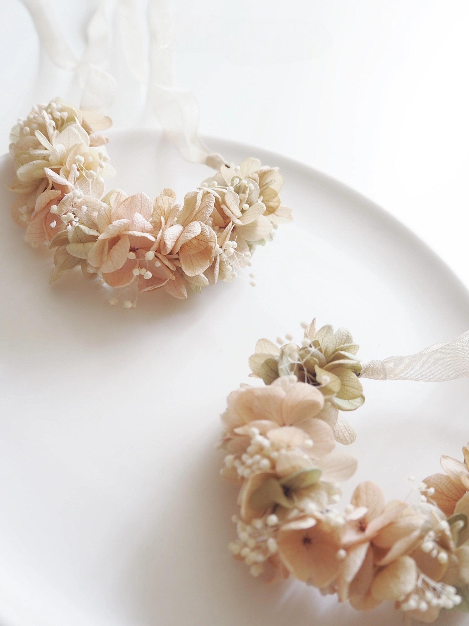 Multiple beige hydrangea corsages arranged for weddings and special events.
