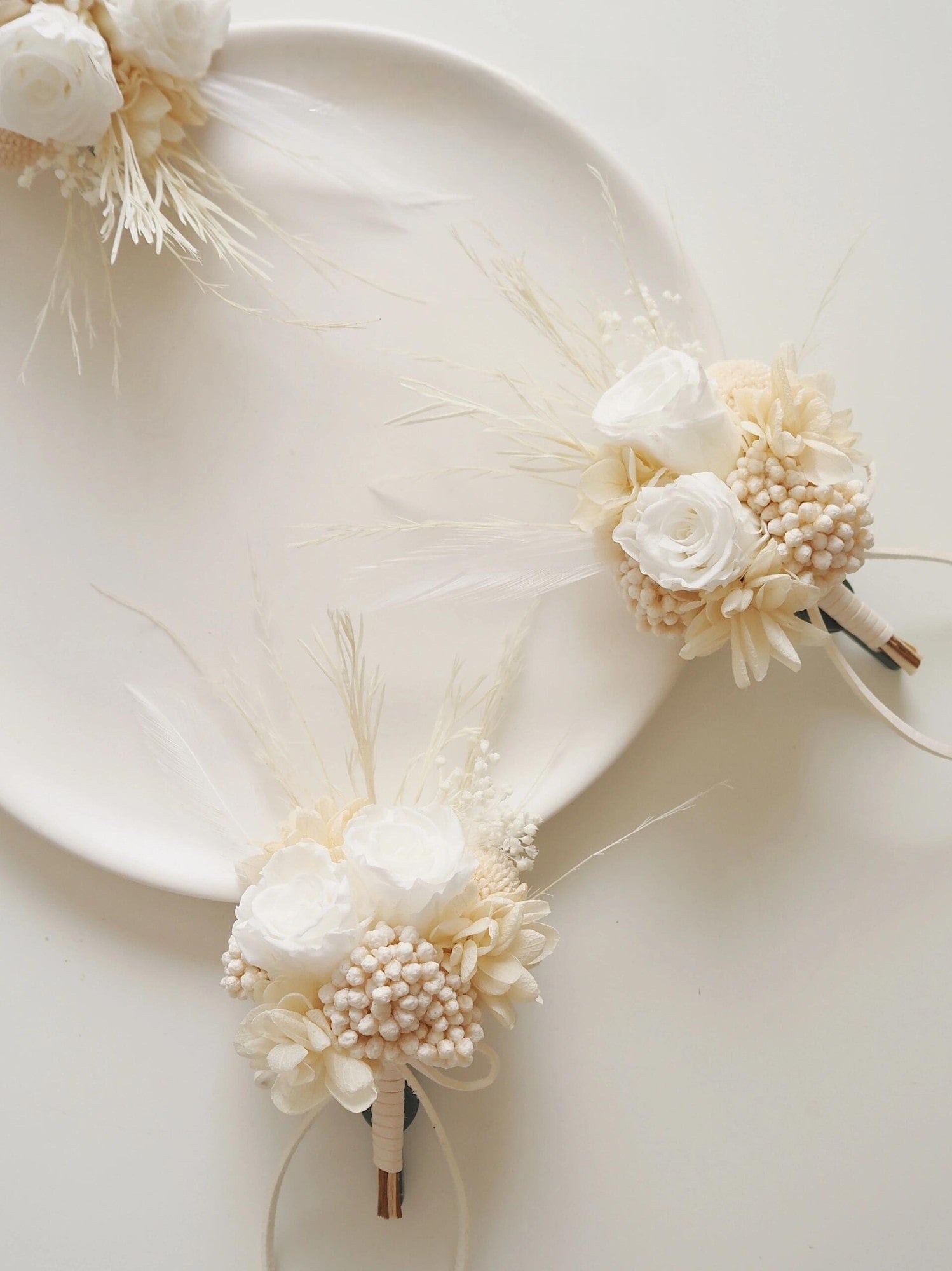 Real preserved flower boutonniere featuring ivory roses and hydrangeas
