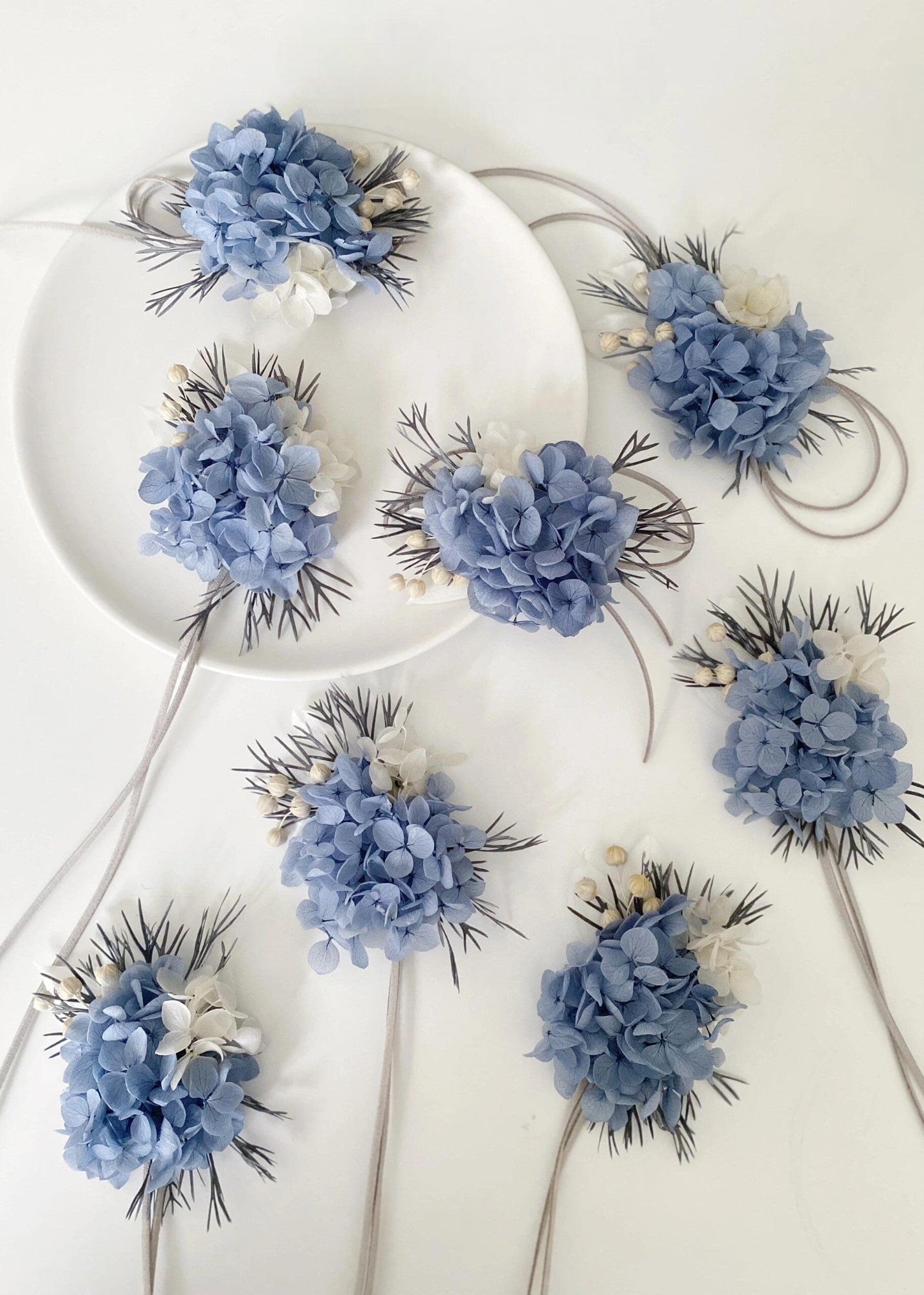 Dusty blue and white hydrangea boutonniere set with preserved flowers
