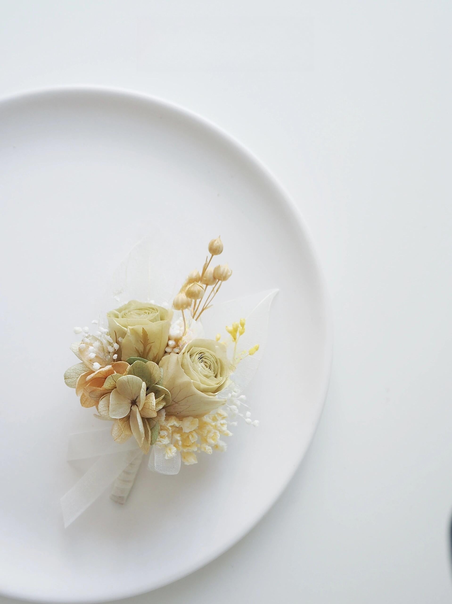 Real preserved flower boutonniere with cream roses and delicate greenery
